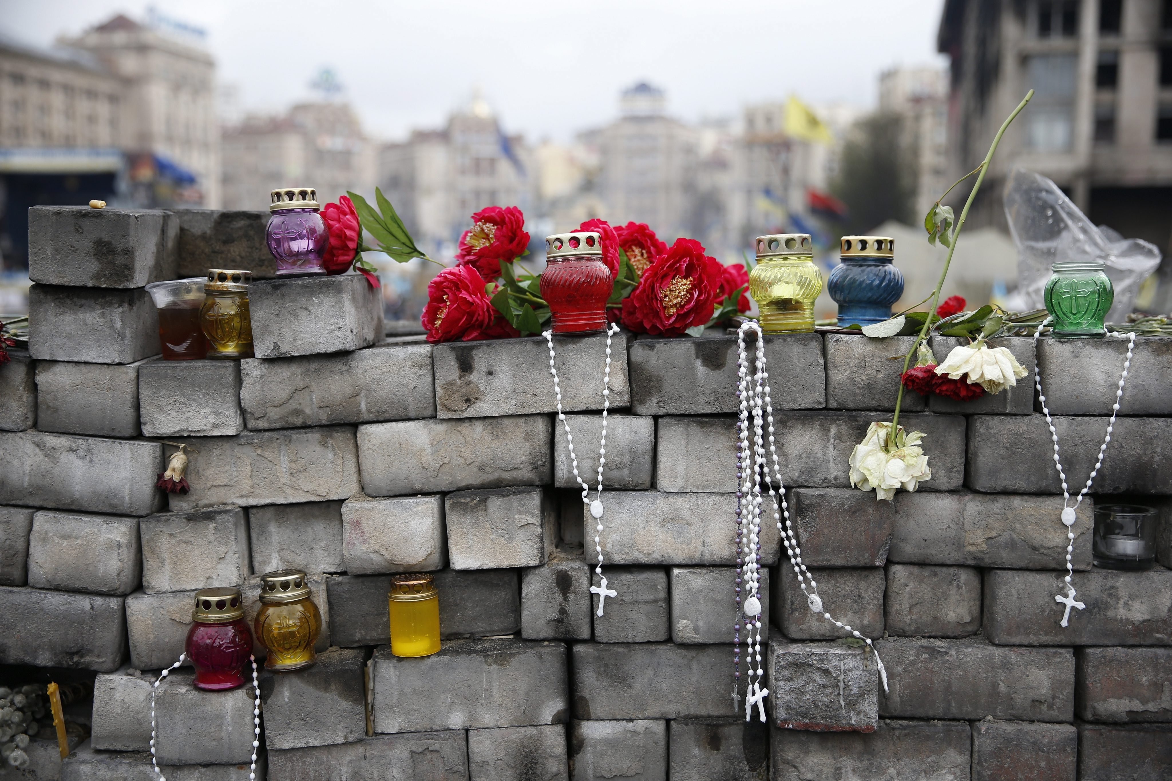 Apr. 14, 2014. Flowers, candles and beads are seen on an improvised wall made of pavement stones at the Maidan, or Independence Square, in Kiev, Ukraine.