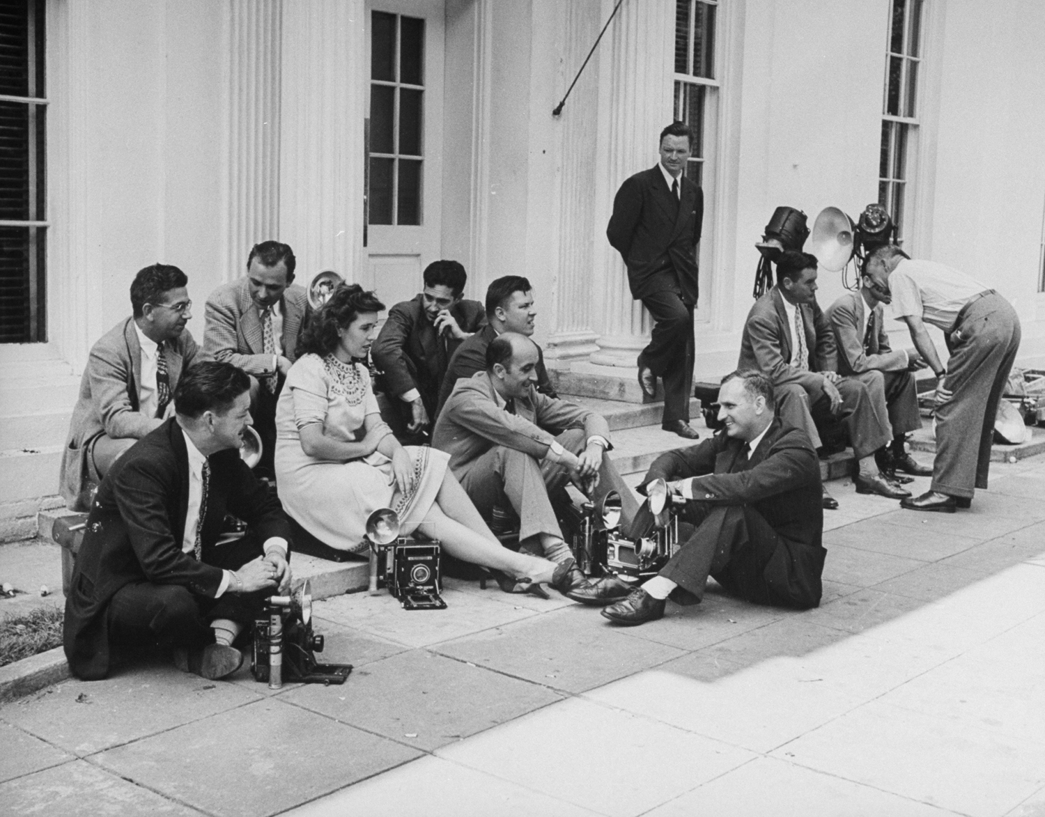 Reporters wait outside the White House for news of Japan's surrender, 1945.