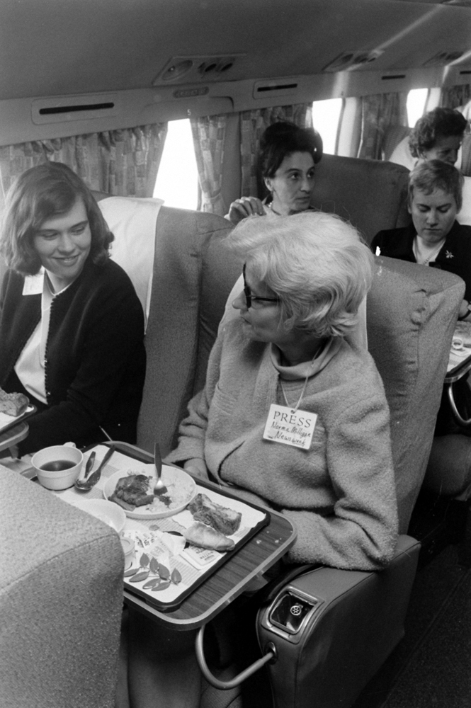 Reporters (incl. Newsweek's Norma Milligan, right, with name tag) on a plane with Lady Bird Johnson, mid-1960s.