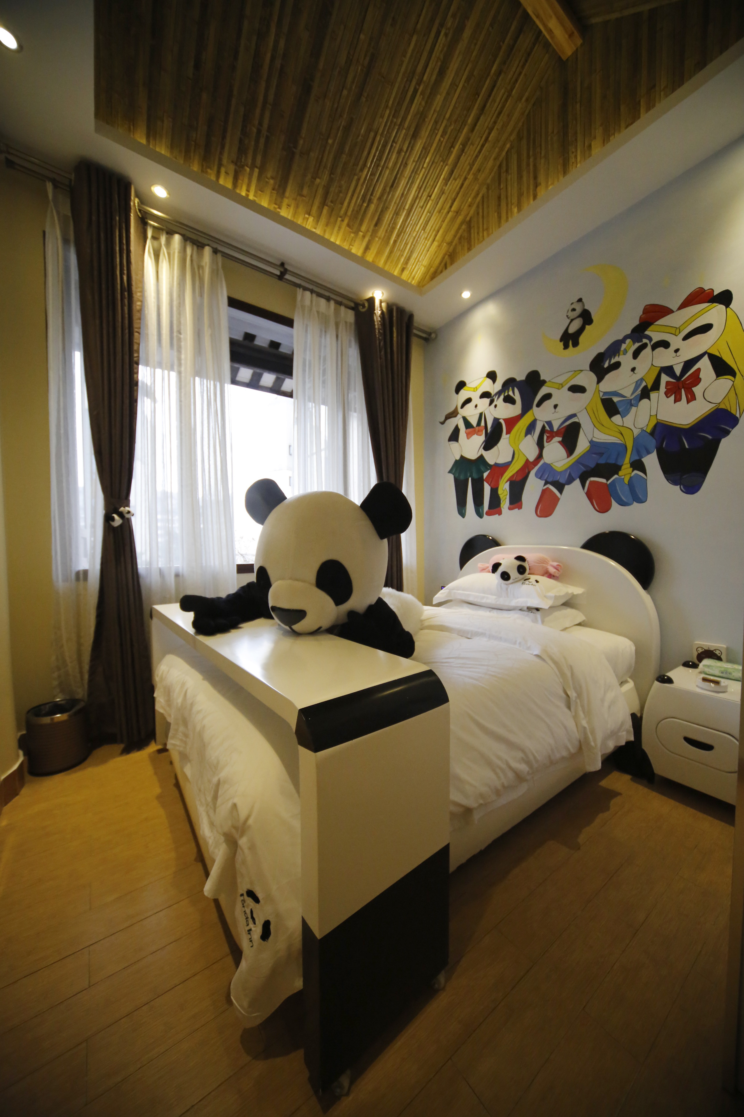 A panda toy on a bed in a room of a panda-themed hotel (AFP/Getty Images)