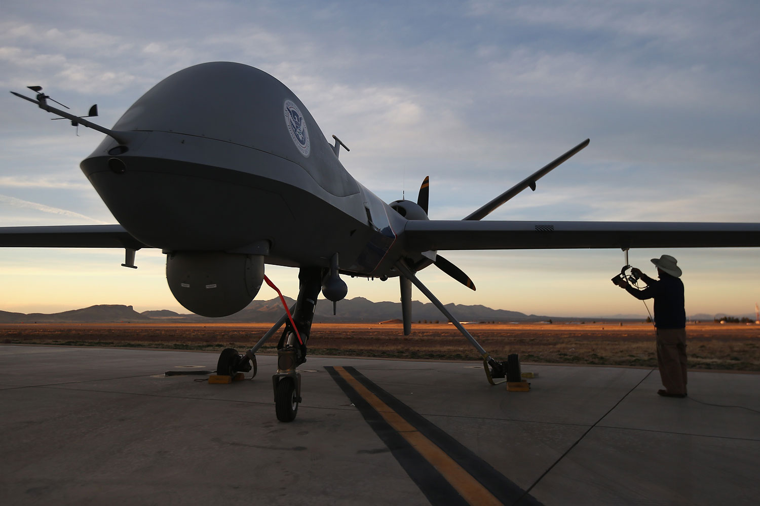 Maintenence personel check a Predator drone on March 7, 2013 in Sierra Vista, Arizona. (John Moore—Getty Images)