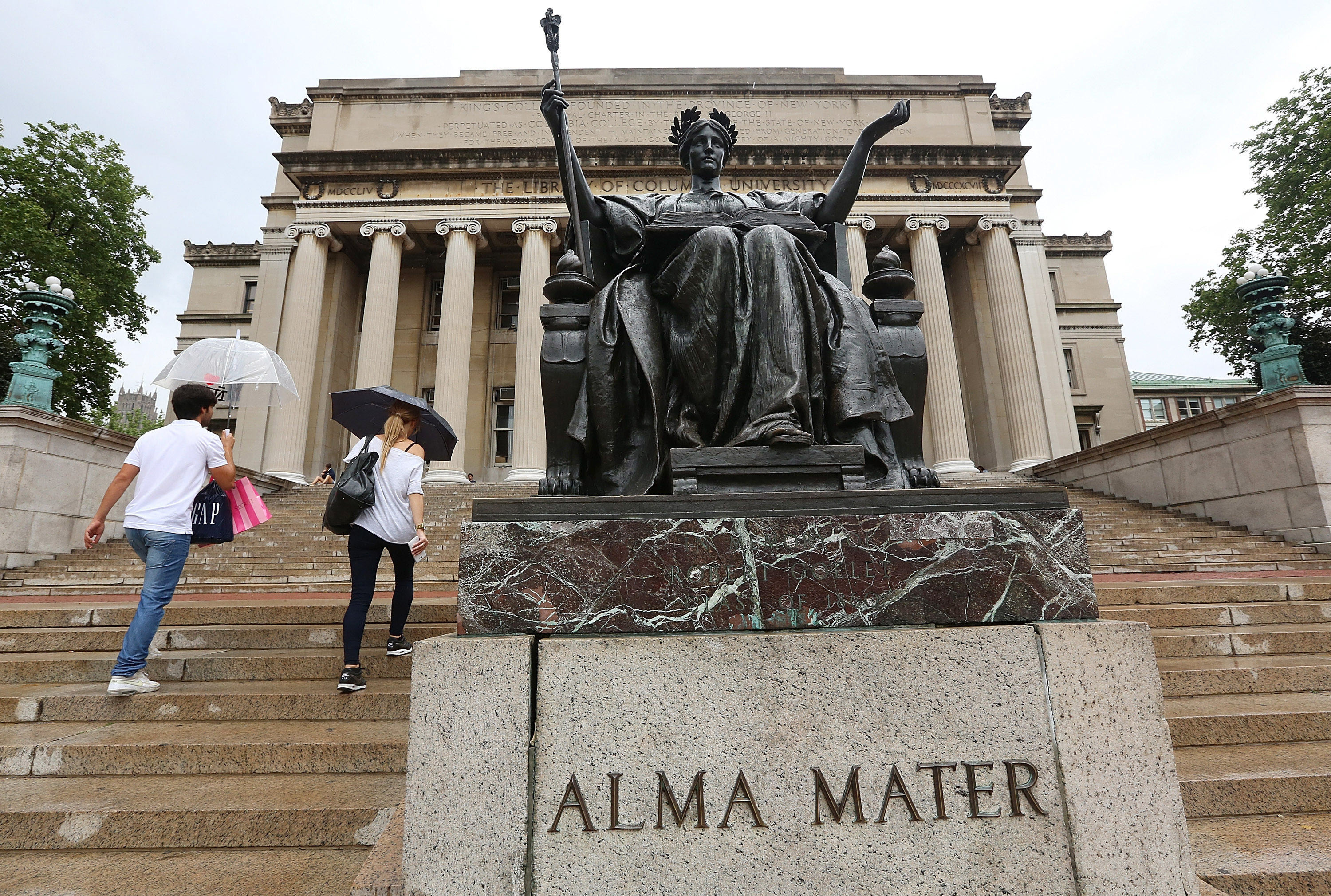 People walk past the Alma Mater statue on the Columbia University campus on July 1, 2013 in New York City. (Mario Tama—Getty Images)