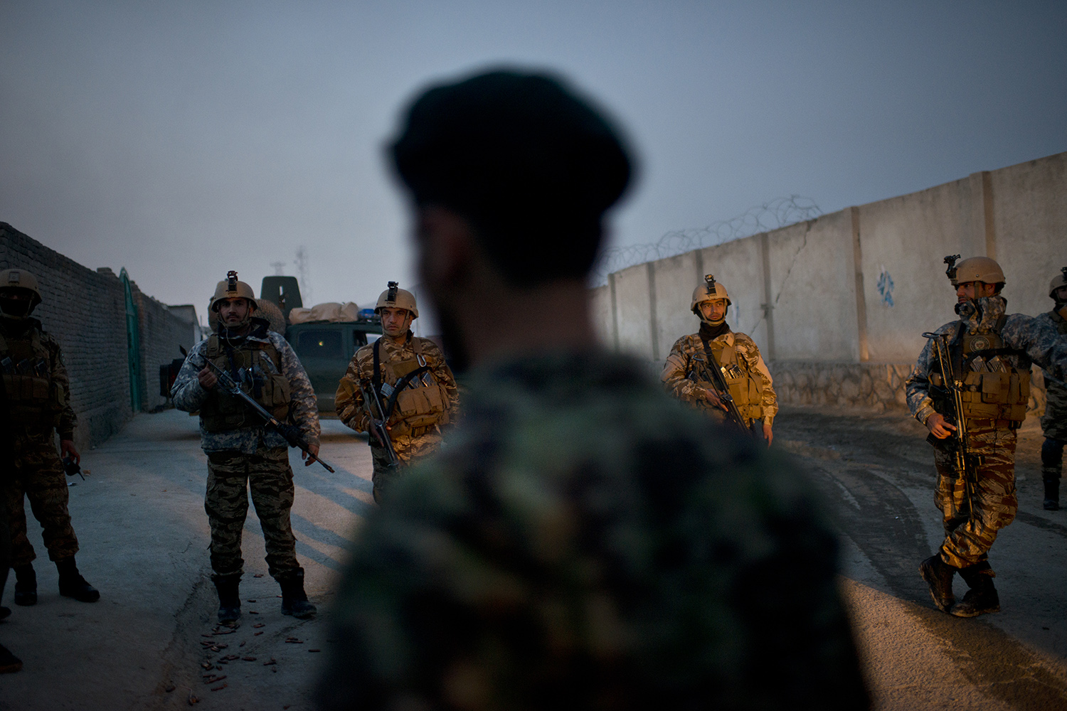 Afghan Security forces stand guard on the perimeter of an ongoing attack at the election headquarters in Kabul,  Afghanistan, March 29, 2014.  The Taliban has declared it will try to derail presidential elections, and there has been a surge in Taliban attacks in the days leading up to voting day in Afghanistan. (Credit: Lynsey Addario for Time Magazine)