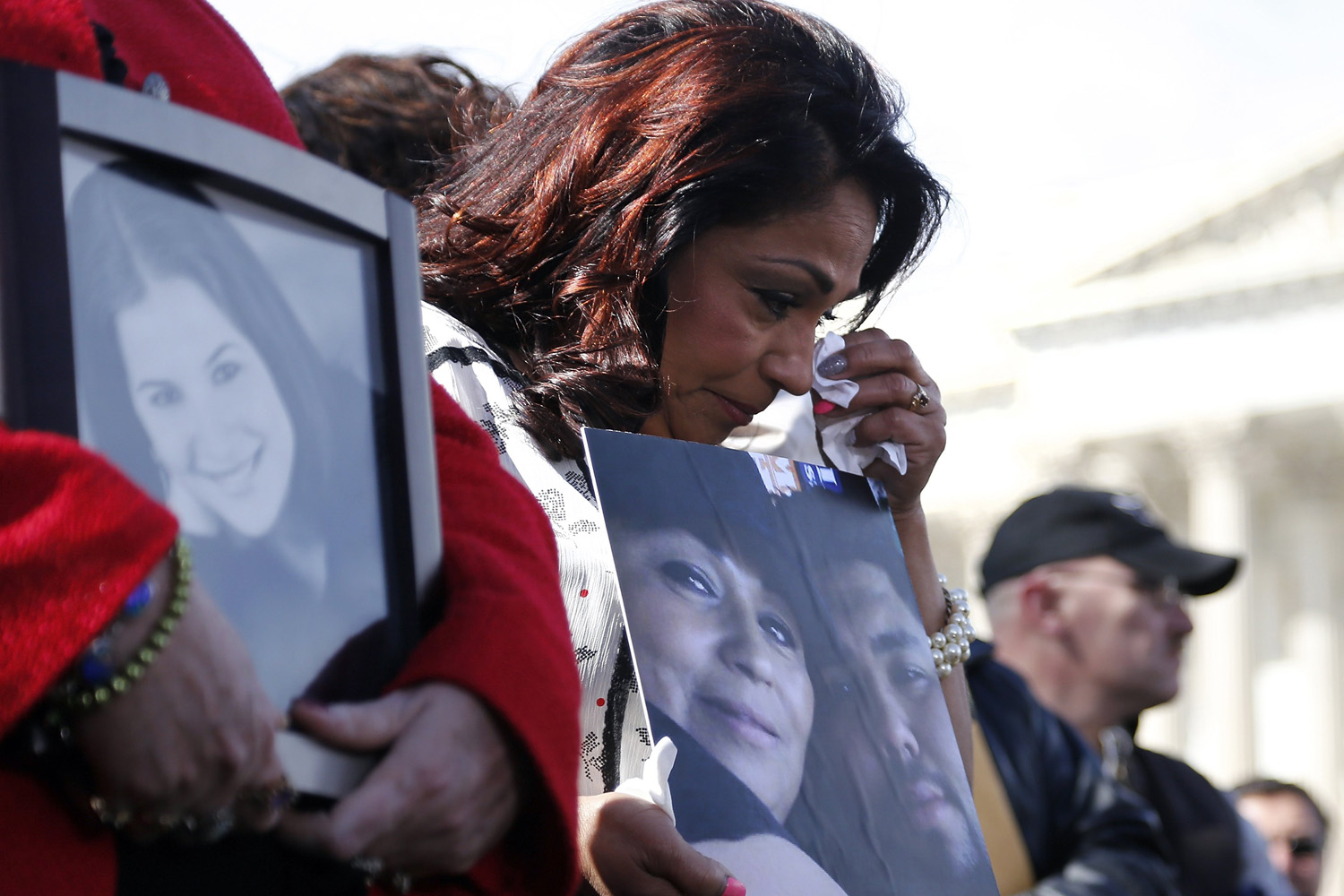 Apr. 1, 2014. Grieving mother Rosie Cortinas (C) holds a picture of her deceased son Amador Cortinas as she and fellow families of victims of the GM recall failure hold a news conference on the U.S. Capitol grounds in Washington.