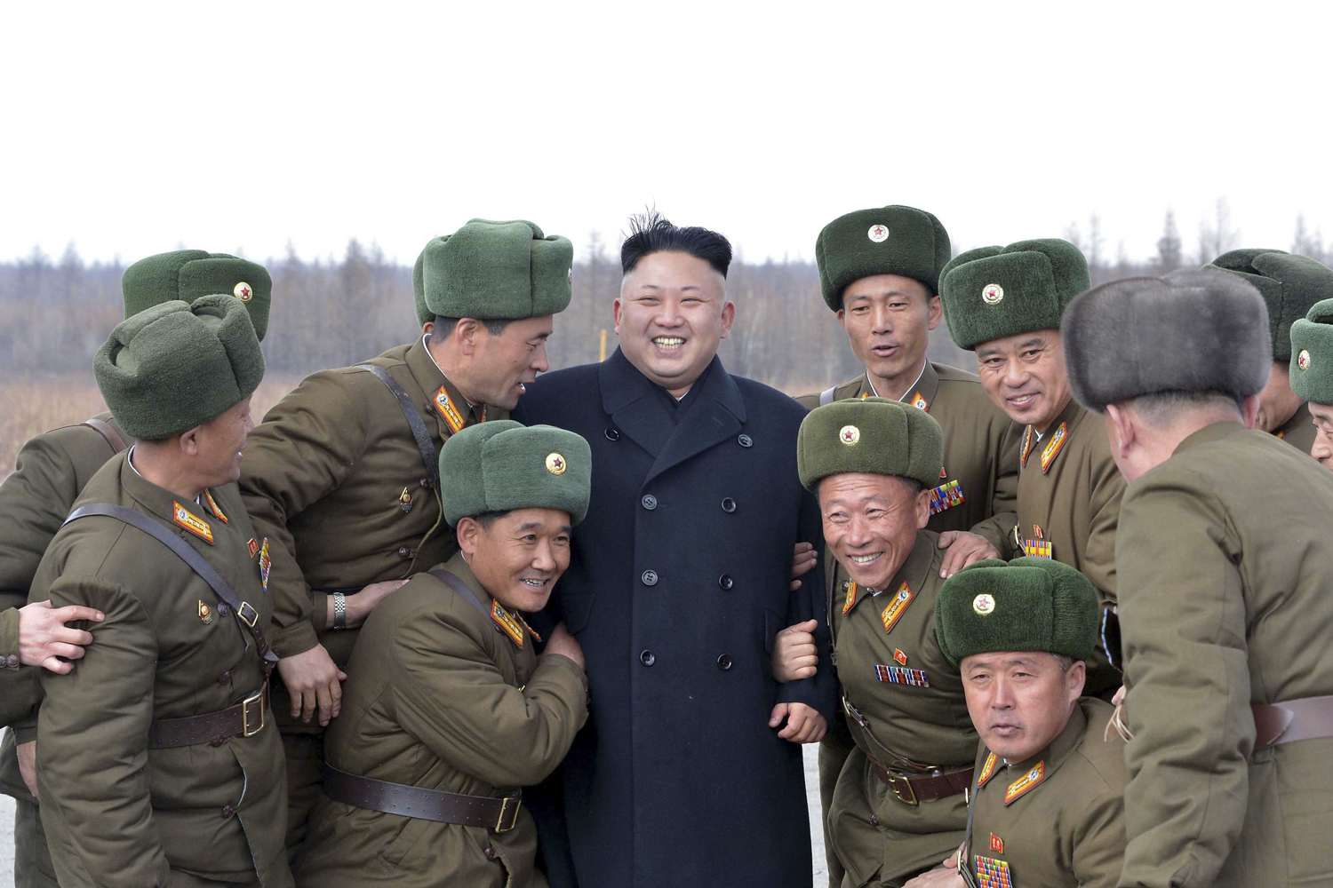 North Korean leader Kim Jong Un smiles as he stands with commanding officers of the combined units of the Korean People's Army in an undated photo released by North Korea's Korean Central News Agency in Pyongyang, April 2, 2014.