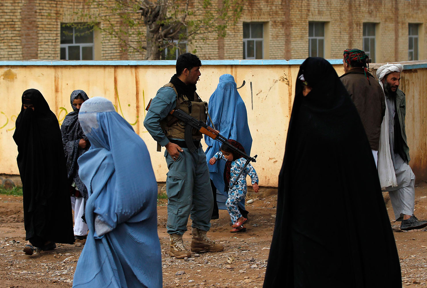 Afghan women arrive to vote at a polling station in Adraskan district