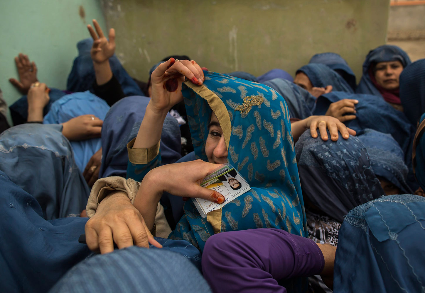 Afghan women wait to cast their ballots at a polling station in Mazar-i-sharif