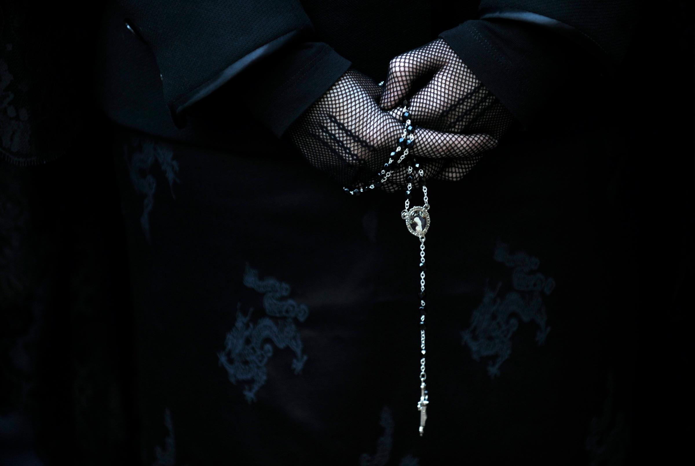 A penitent takes part in the procession of the "Silencio y la Santa Cruz" brotherhood during Holy Week in Oviedo