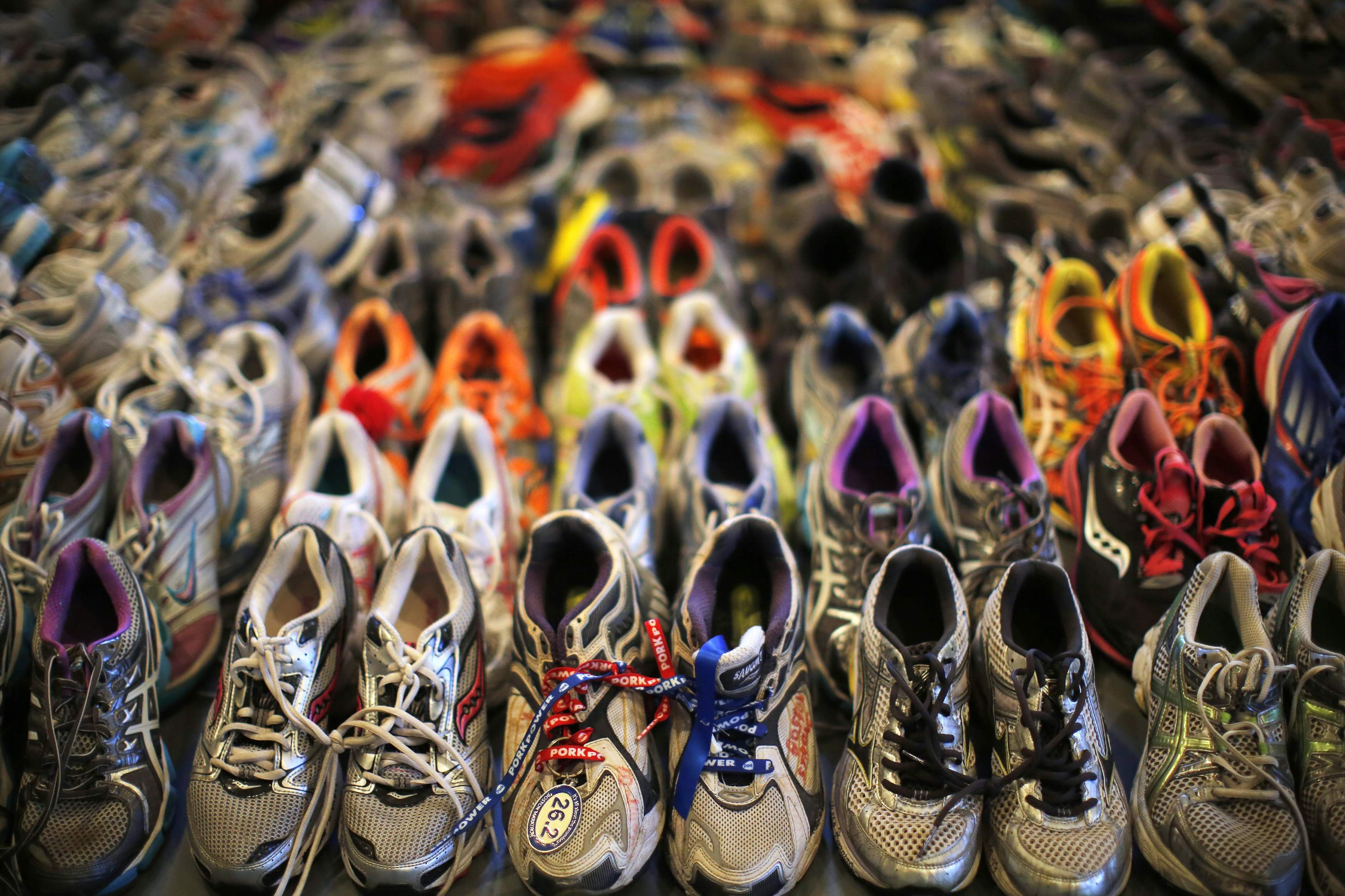 Apr. 16, 2014. Running shoes left at the makeshift memorial following the 2013 Boston Marathon bombings are displayed in an exhibit titled  Dear Boston: Messages from the Marathon Memorial  at the Boston Public Library in Boston, Massachusetts.