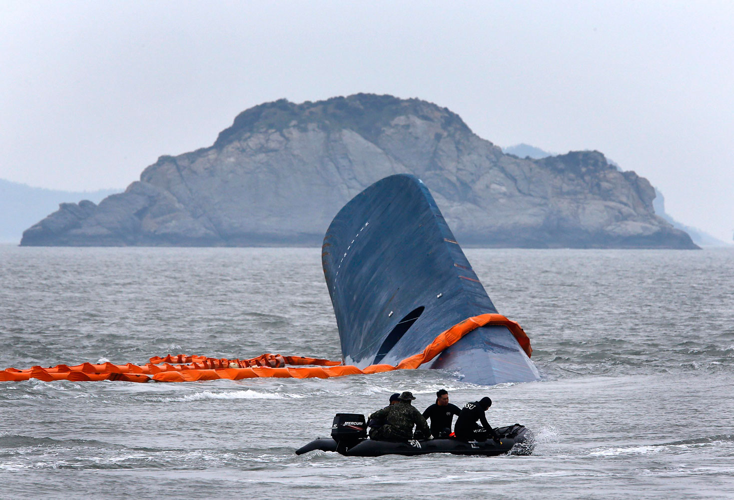 A vessel involved in salvage operations passes near the upturned South Korean ferry <i>Sewol</i> in the sea off Jindo April 17, 2014. (Kim Kyung-Hoon—Reuters)