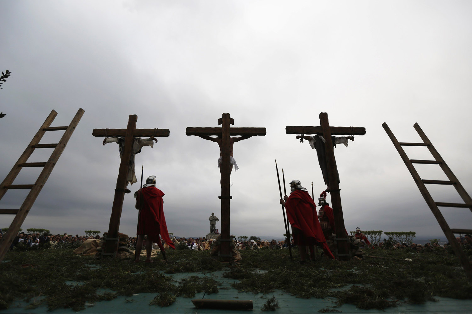 Worshippers re-enact "Stations of the Cross" during procession on Good Friday in Ourem