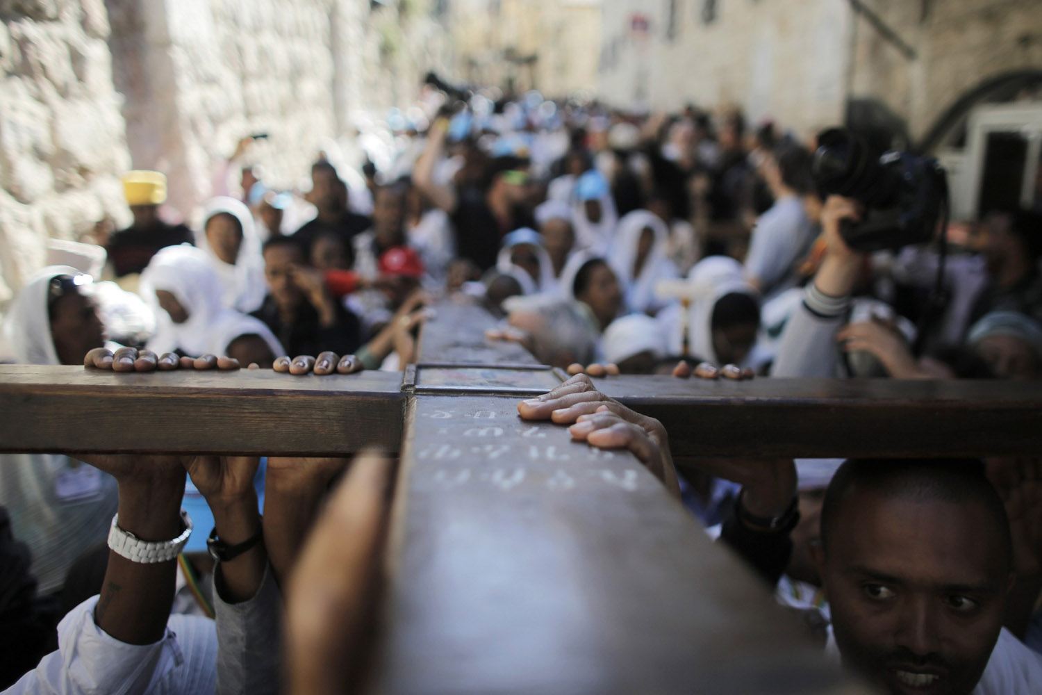 Christian worshippers carry a cross during a procession along the Via Dolorosa on Good Friday in Jerusalem's Old City