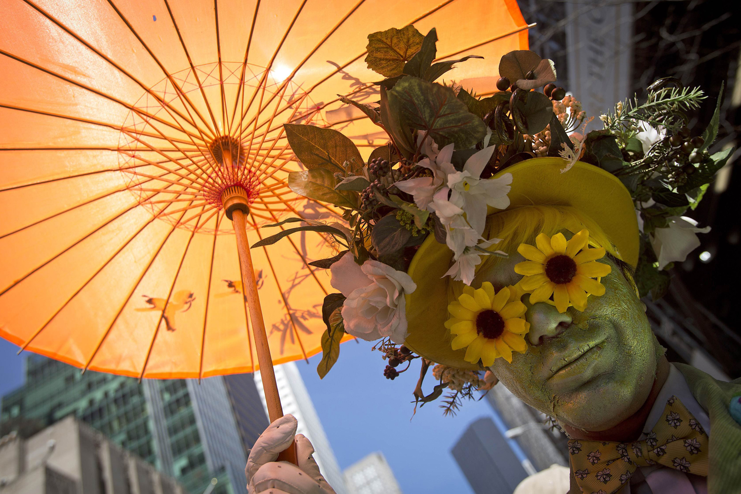 A participant dressed in costume holds an umbrella at the annual Easter Bonnet Parade in New York