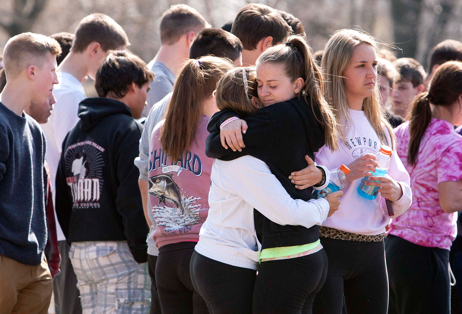 Students mourn in front of Jonathan Law High School in Milford