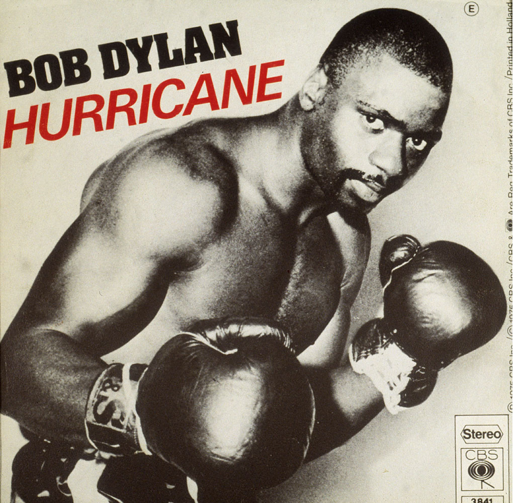 A view of the sleeve cover photograph of rock singer and songwriter Bob Dylan's 45 RPM single 'Hurricane,' showing boxer Rubin 'Hurricane' Carter in a fighting stance