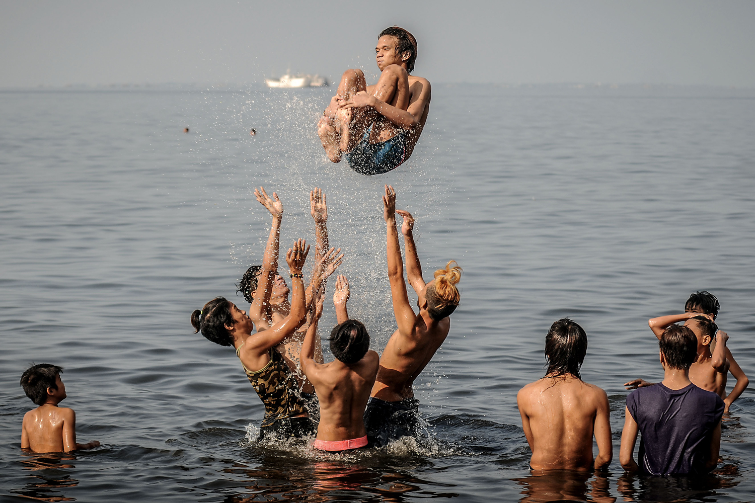 Filipinos cool off in the polluted waters of Manila Bay during Easter Sunday in Manila, Philippines, April 20, 2014.