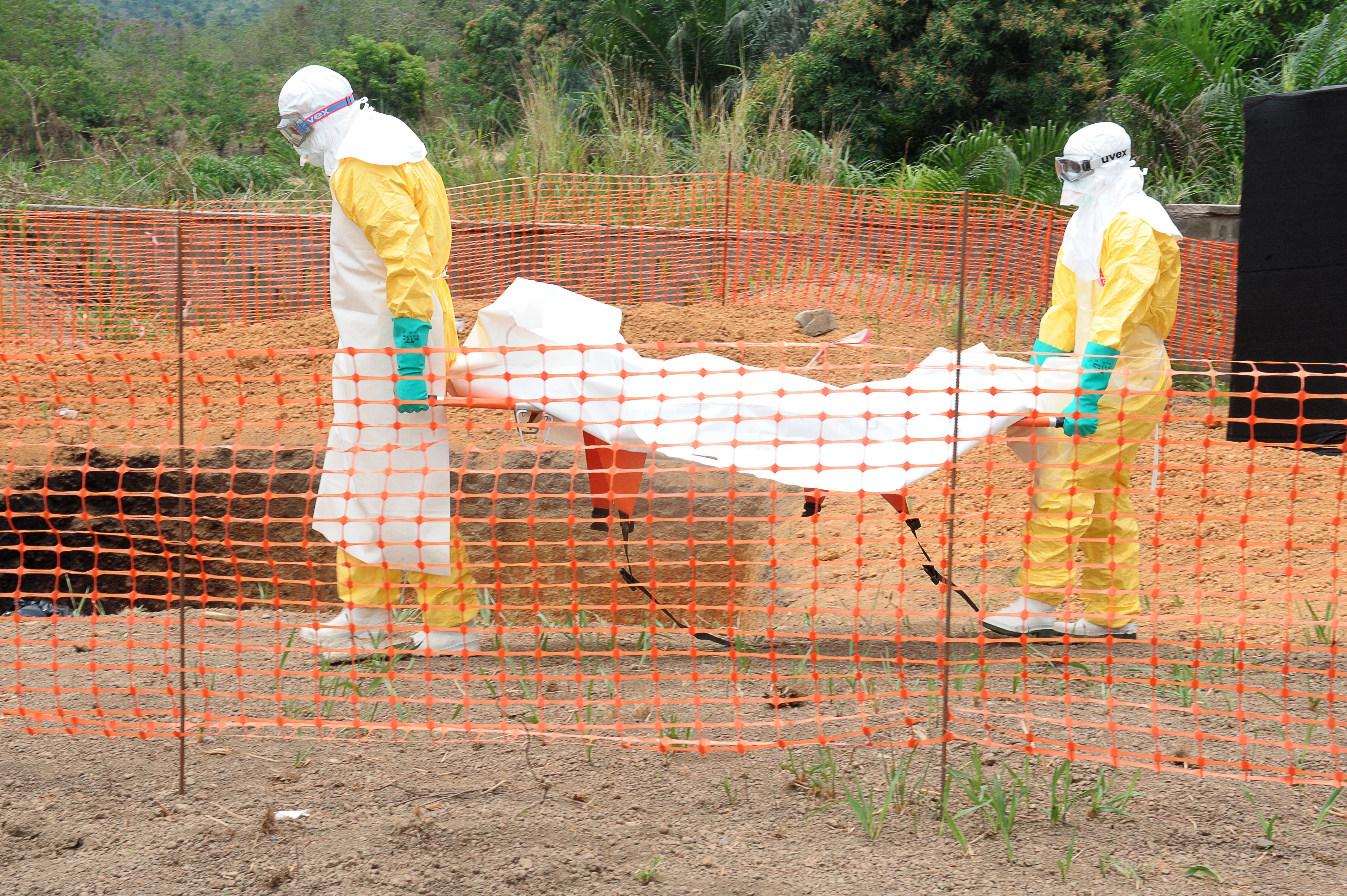 Doctors Without Borders staff carry the body of a person killed by viral haemorrhagic fever, at a center for victims of the Ebola virus in Guekedou, on April 1, 2014. (Seyllou—AFP/Getty Images)
