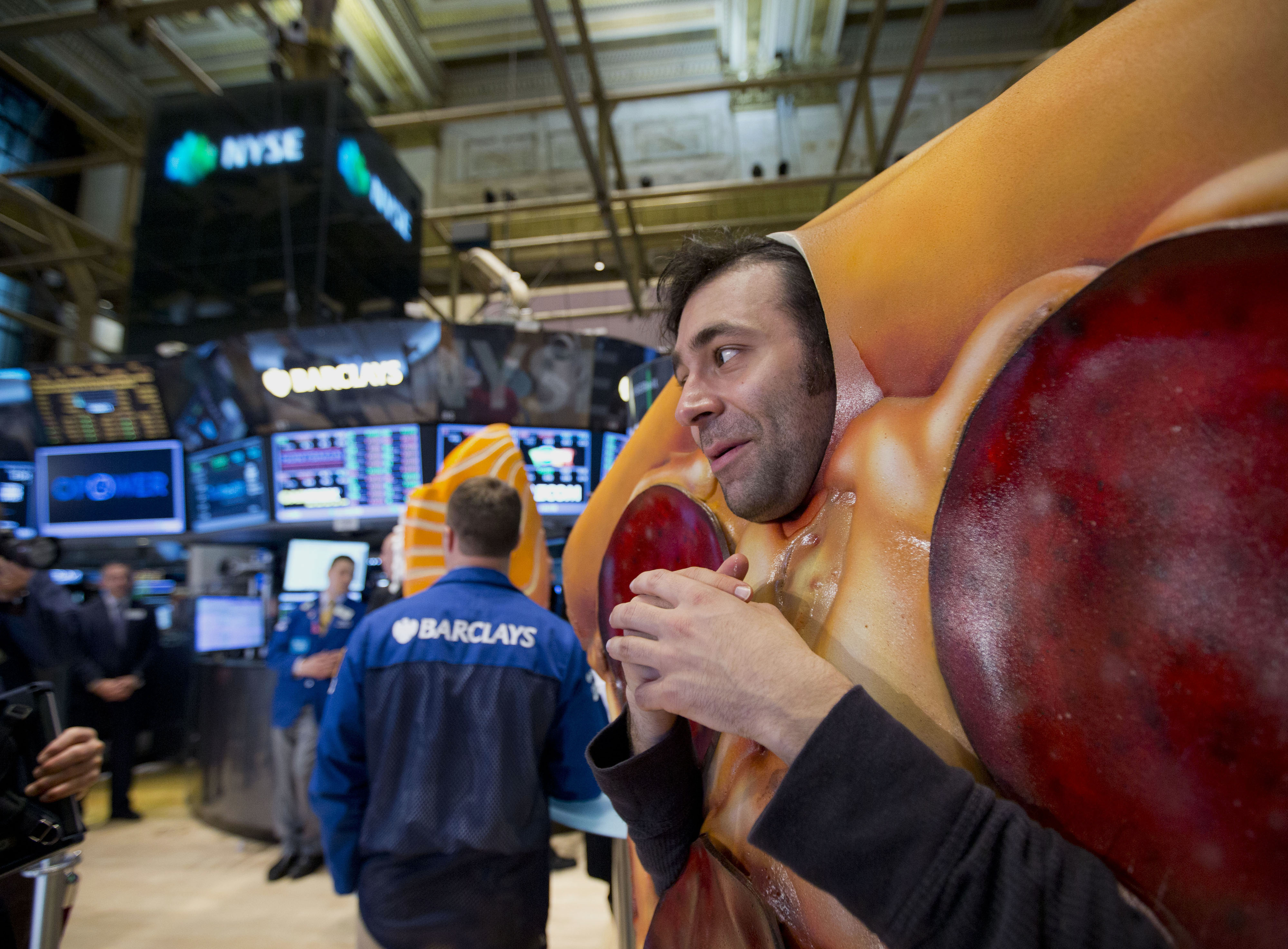 Actors dressed in Grubhub Inc. costumes interact with traders on the floor of the New York Stock Exchange in New York, U.S., on Friday, April 4, 2014. (Bloomberg&mdash;Bloomberg via Getty Images)
