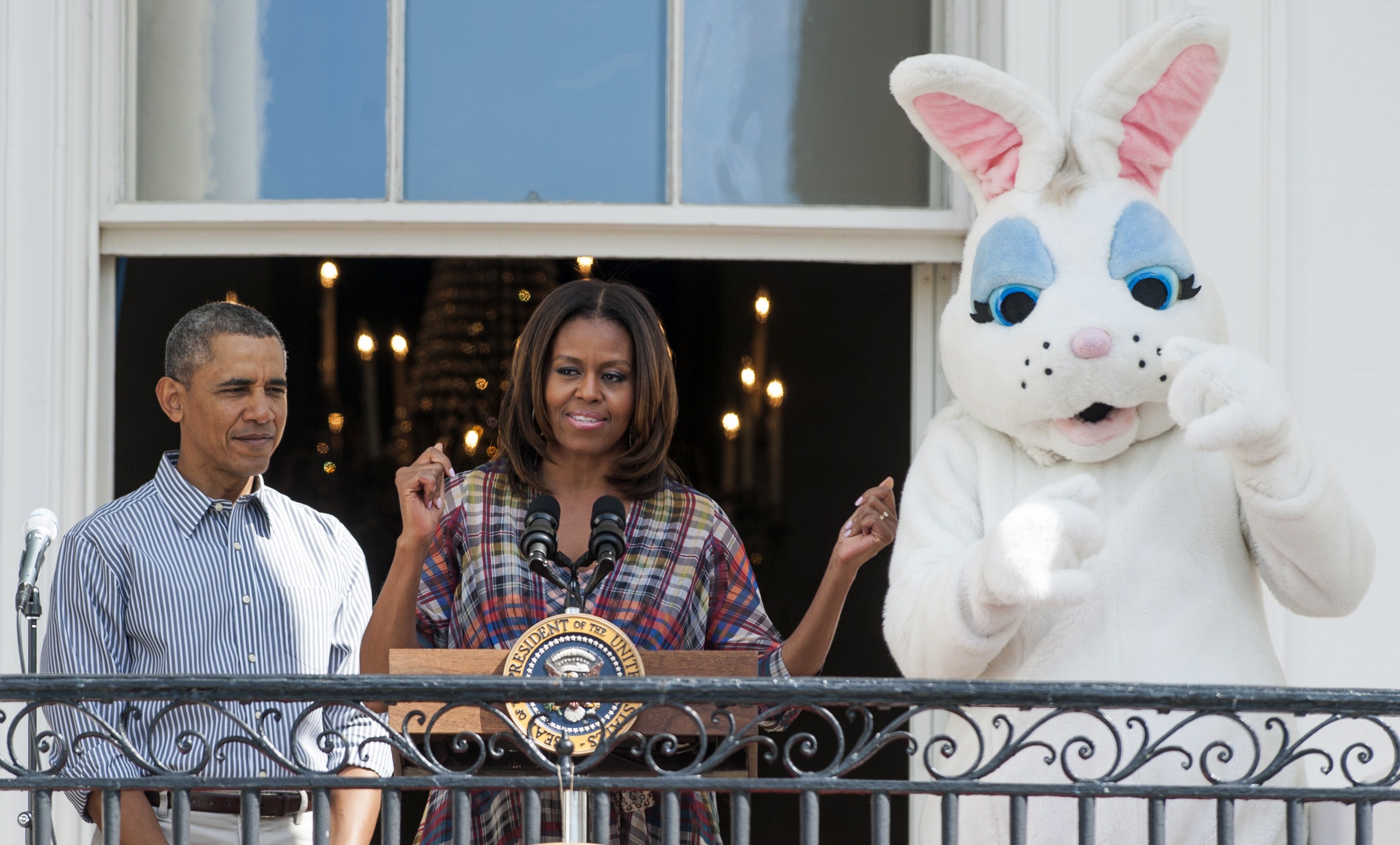 U.S. First Lady Michelle Obama speaks alongside President Barack Obama and the Easter Bunny during the annual White House Easter Egg Roll on the South Lawn of the White House in Washington, D.C., on April 21, 2014 (SAUL LOEB&mdash;AFP/Getty Images)
