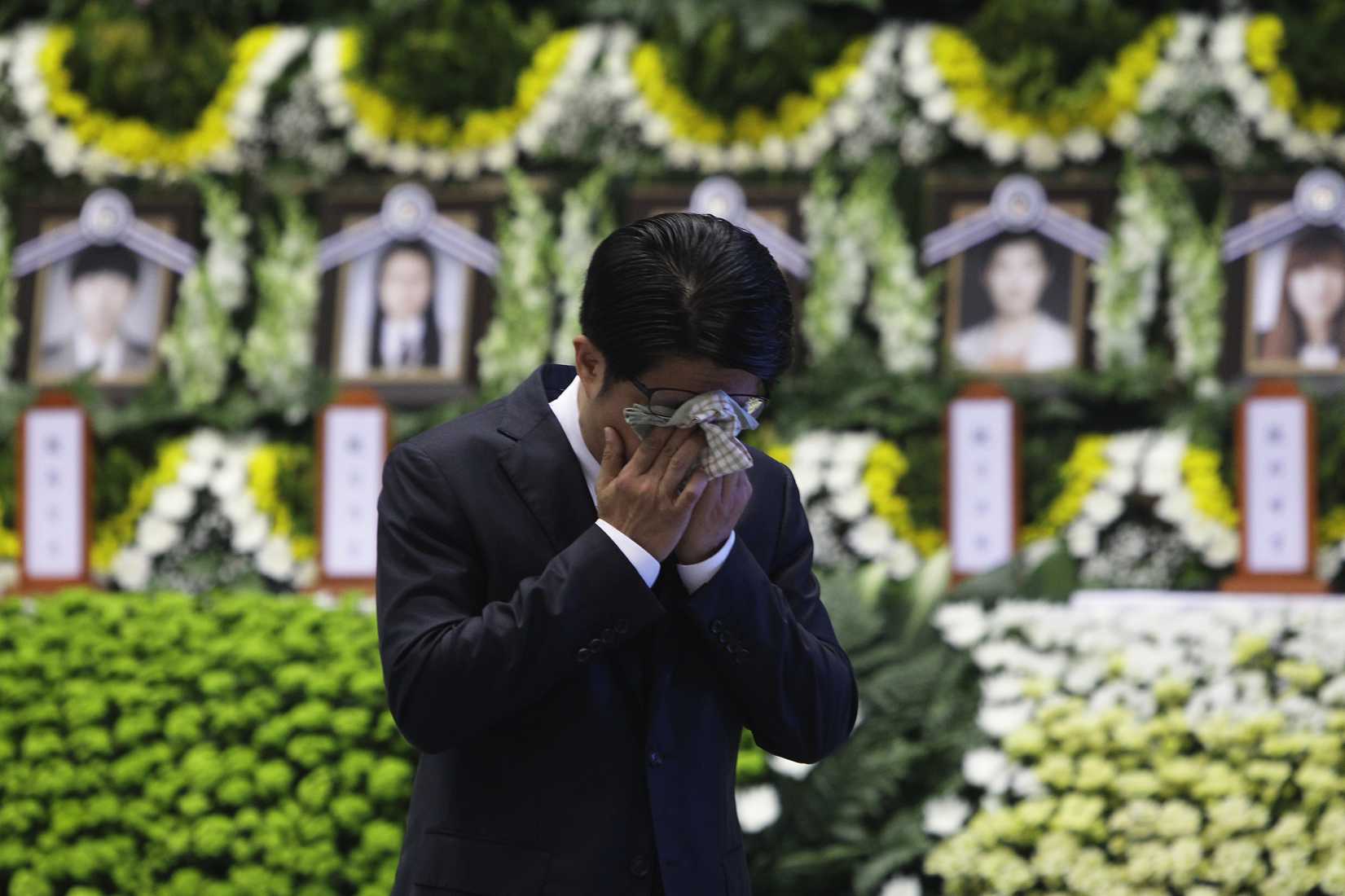 A man weeps after tribute at a group memorial altar for victims of sunken passengers ship at the Ansan Olympic Memorial Hall on April 23, 2014 in Ansan, South Korea. (Chung Sung-Jun—Getty Images)