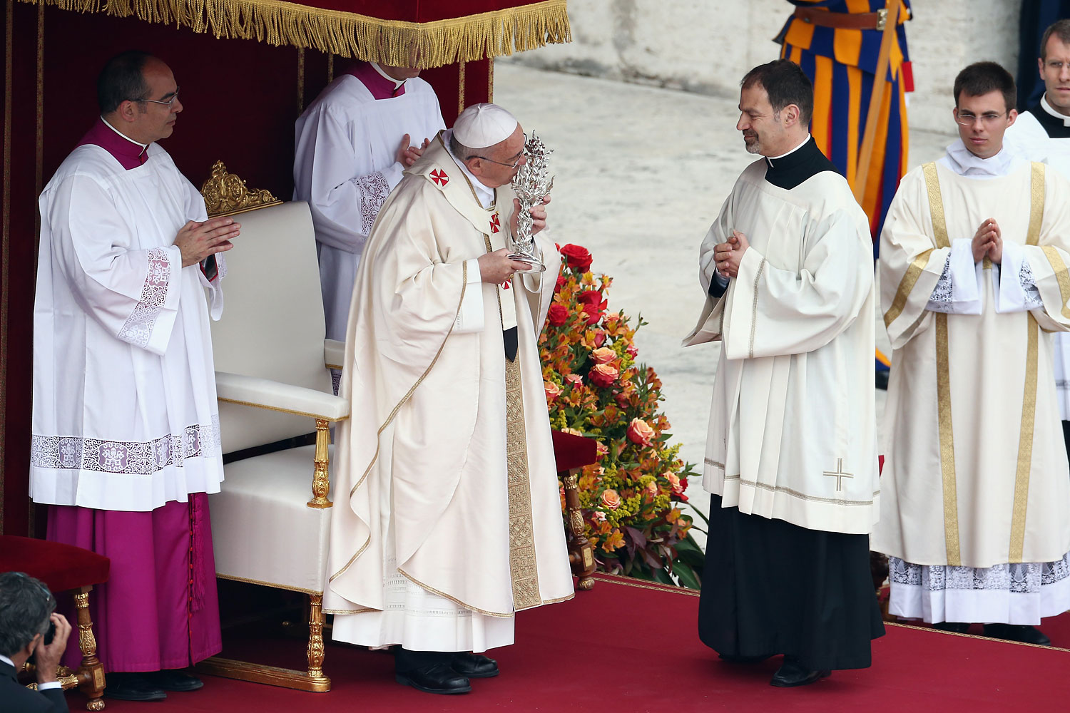 Pope Francis kisses the relic of Pope John XXIII as he leads the canonisation mass.