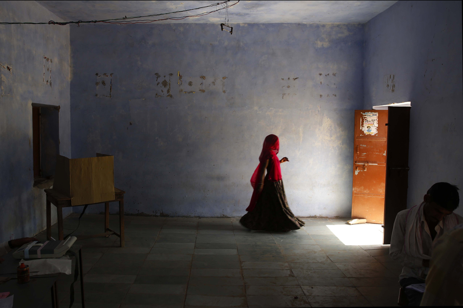 Apr. 24, 2014. An Indian woman leaves after casting her vote in a village near Sawai Madhopur, in the Indian state of Rajasthan. With 814 million eligible voters, India is voting in phases over six weeks. Results are expected May 16.