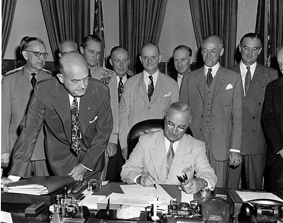 With a stroke of his pen, President Harry Truman finished changing the name of the Department of War to the Department of Defense in 1949. (Truman Library)