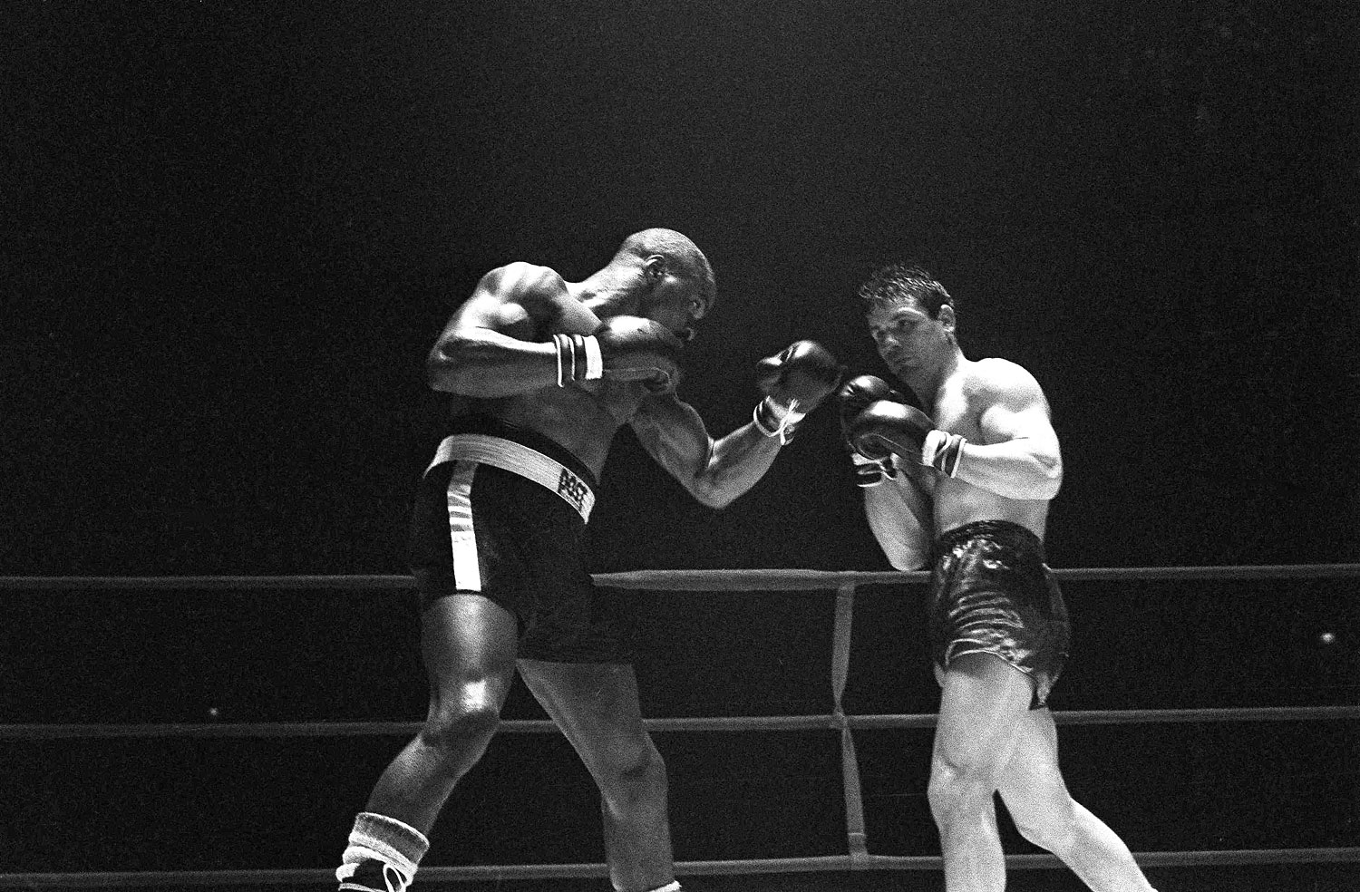 Rubin "Hurricane" Carter, left, knocks out Italian boxer Fabio Bettini in the 10th and last round of their fight at the Falais Des Sports in Paris, Feb. 23, 1965. (AP)