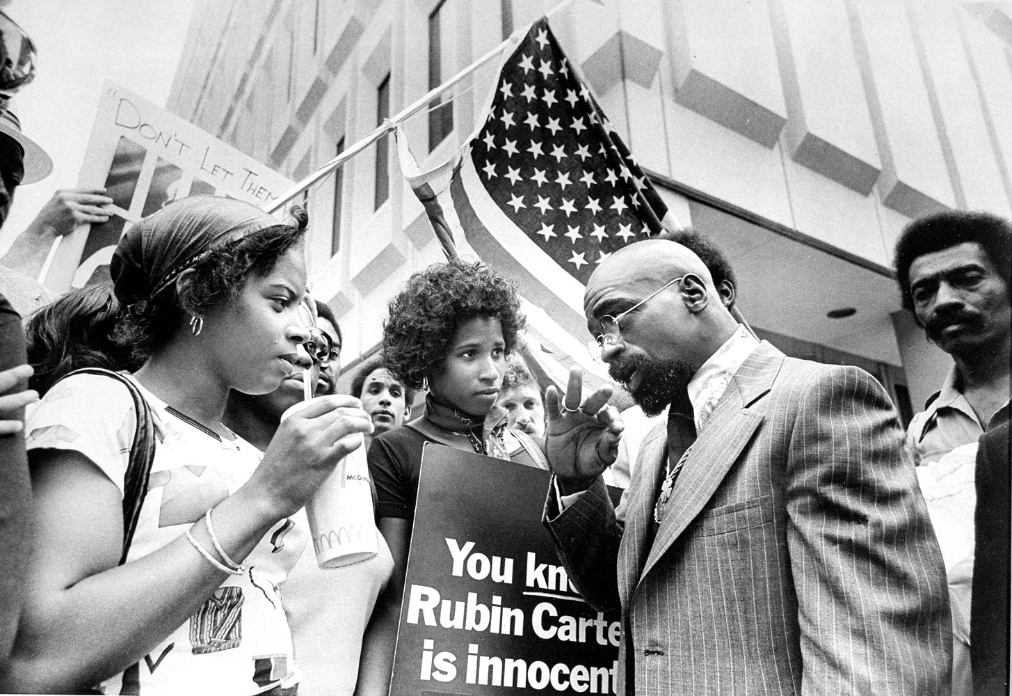 Boxer Rubin Hurricane Carter talks to people picketing on his behalf outside the Passaic County Court.