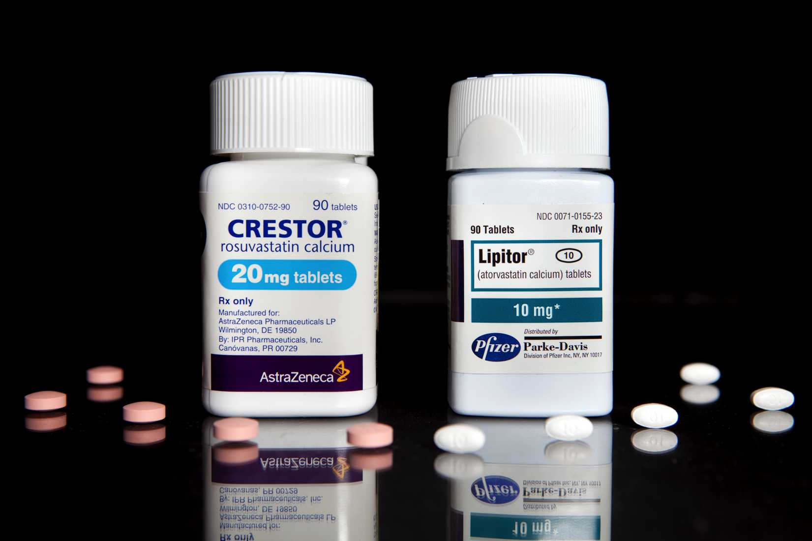 Cholesterol drugs, Crestor, left, manufactured by AstraZeneca Plc, and Lipitor, manufactured by Pfizer Inc., are arranged for a photrograph at New London Pharmacy in New York, U.S., on Tuesday, April 6, 2010. (JB Reed—Bloomberg / Getty Images)
