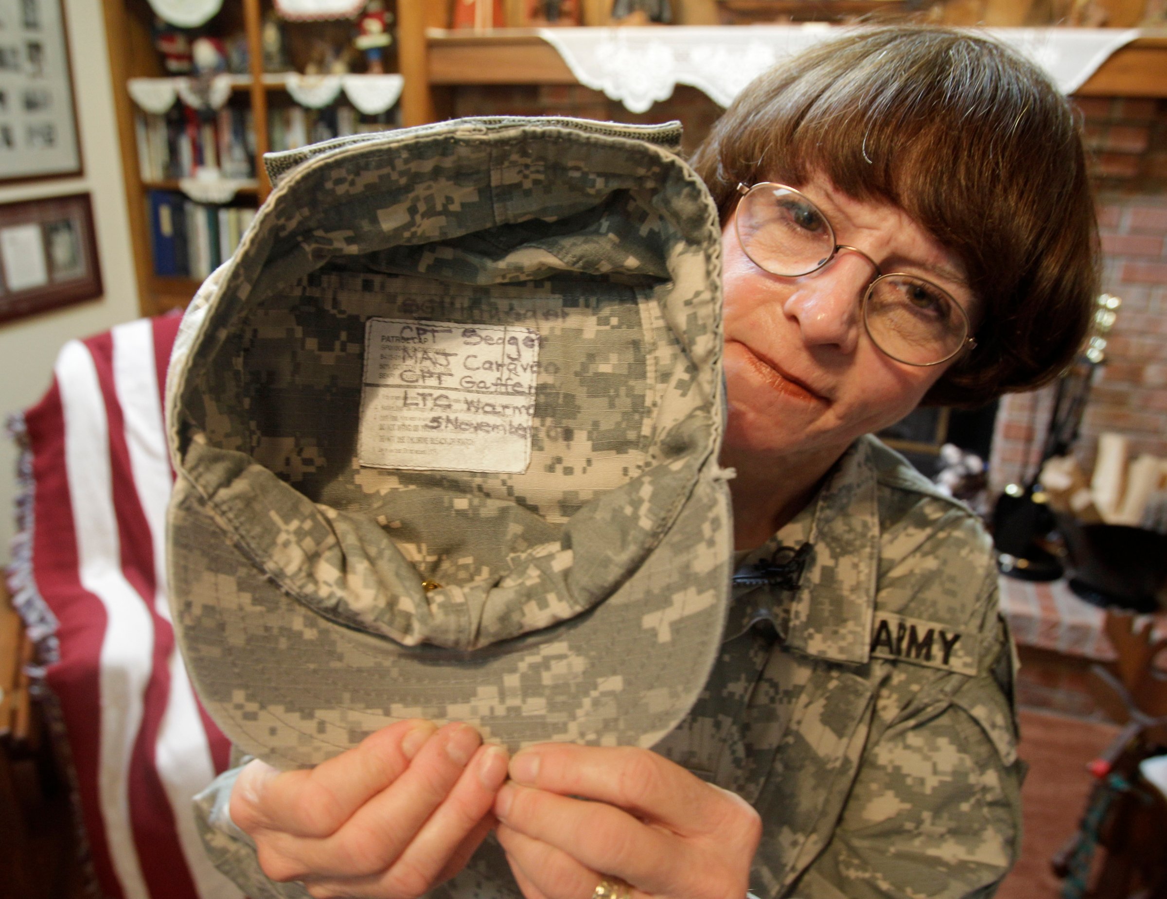 U.S. Army Col. Kathy Platoni holds up her cap at her home in Beaver Creek, Ohio, Nov. 1, 2010.