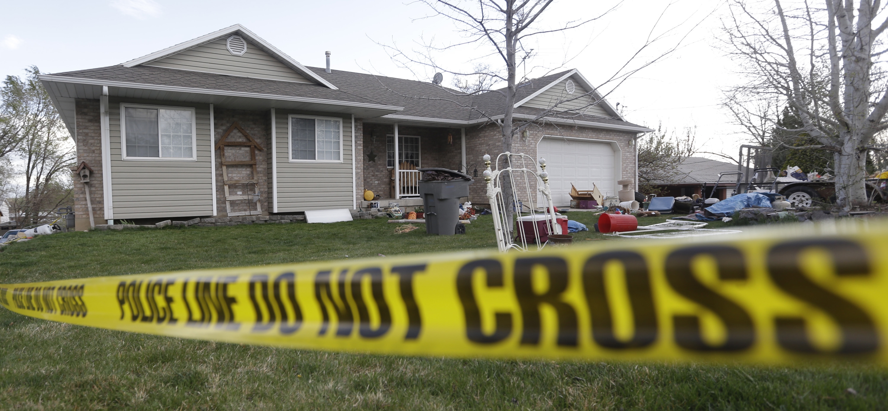 Police tape surrounds the Utah home of Megan Huntsman, who admitted to killing six of her infant children and hiding their bodies (Rick Bowmer&mdash;AP)