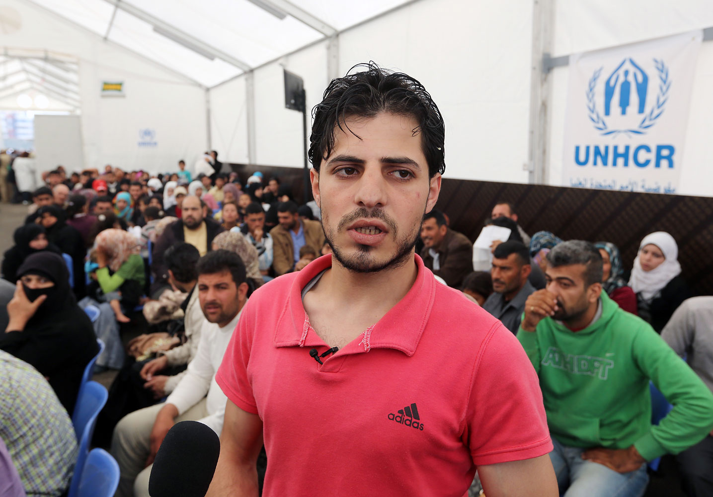 Syrian refugee Yahya, speaks to journalists at the United Nations High Commissioner for Refugees (UNHCR) registration center in the northern city of Tripoli, Lebanon, April 3, 2014. The teenager from central Syria became the one millionth Syrian refugee to register in Lebanon. (Bilal Hussein—AP)