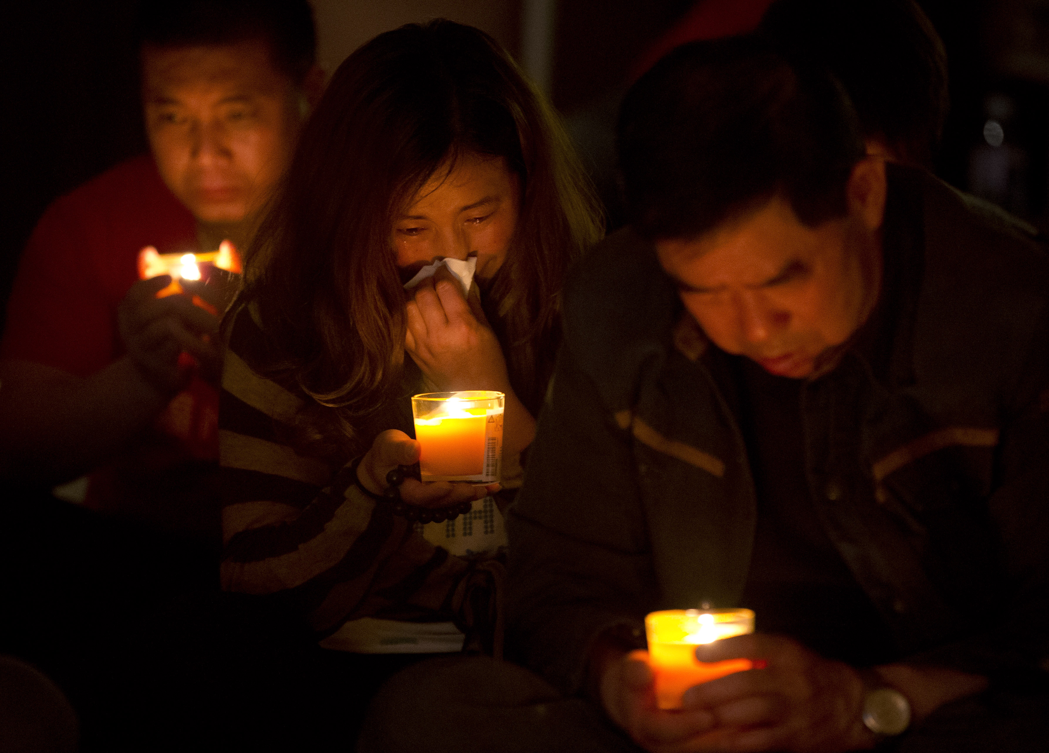 A woman cries as she and others attend a vigil for their loved ones, who were on the missing Malaysia Airlines Flight 370, at a hotel in Beijing on April 8, 2014 (Andy Wong—AP)