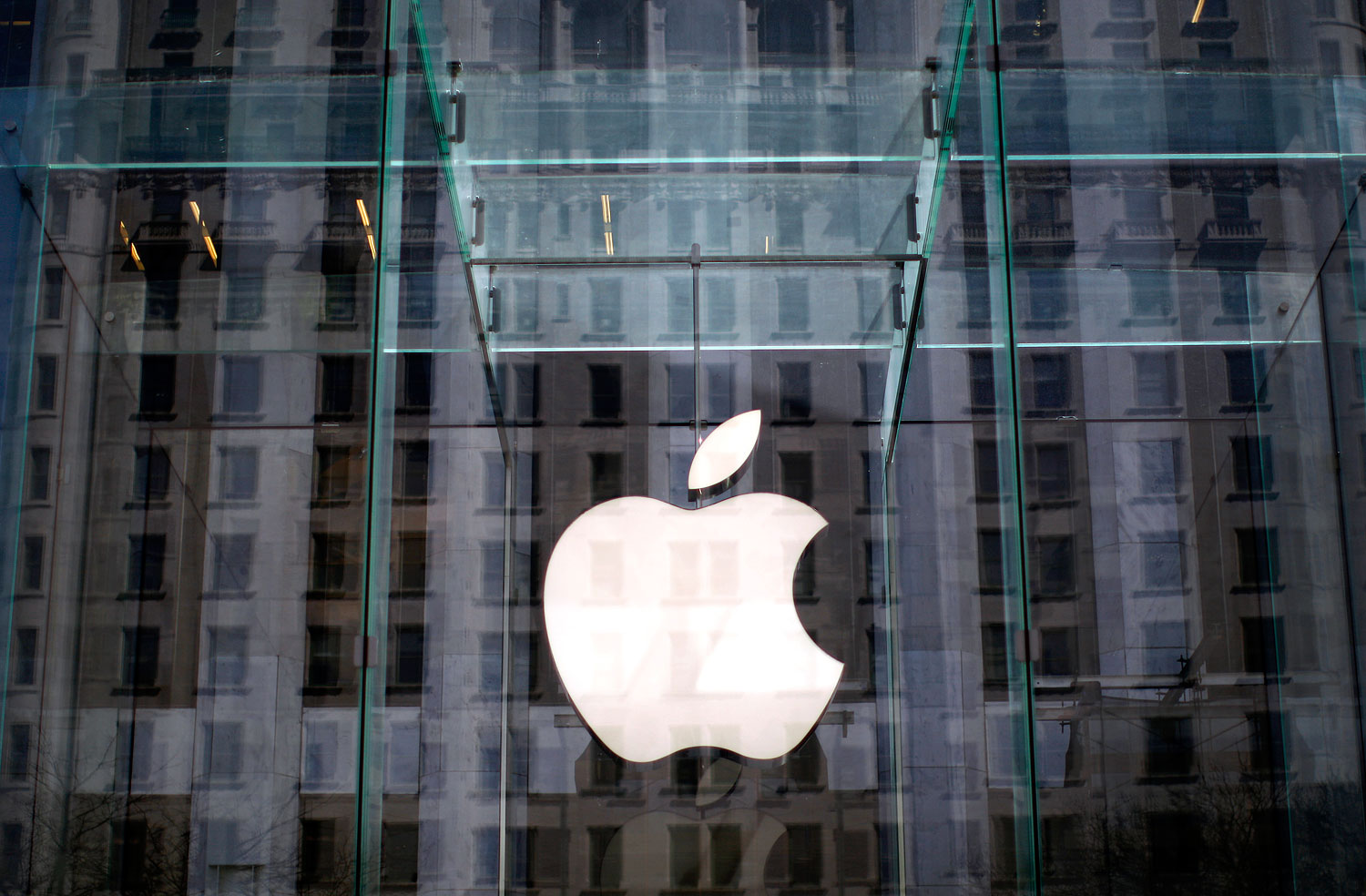 The Apple logo hangs inside the glass entrance to the Apple Store on 5th Avenue in New York City. (Mike Segar—Reuters)