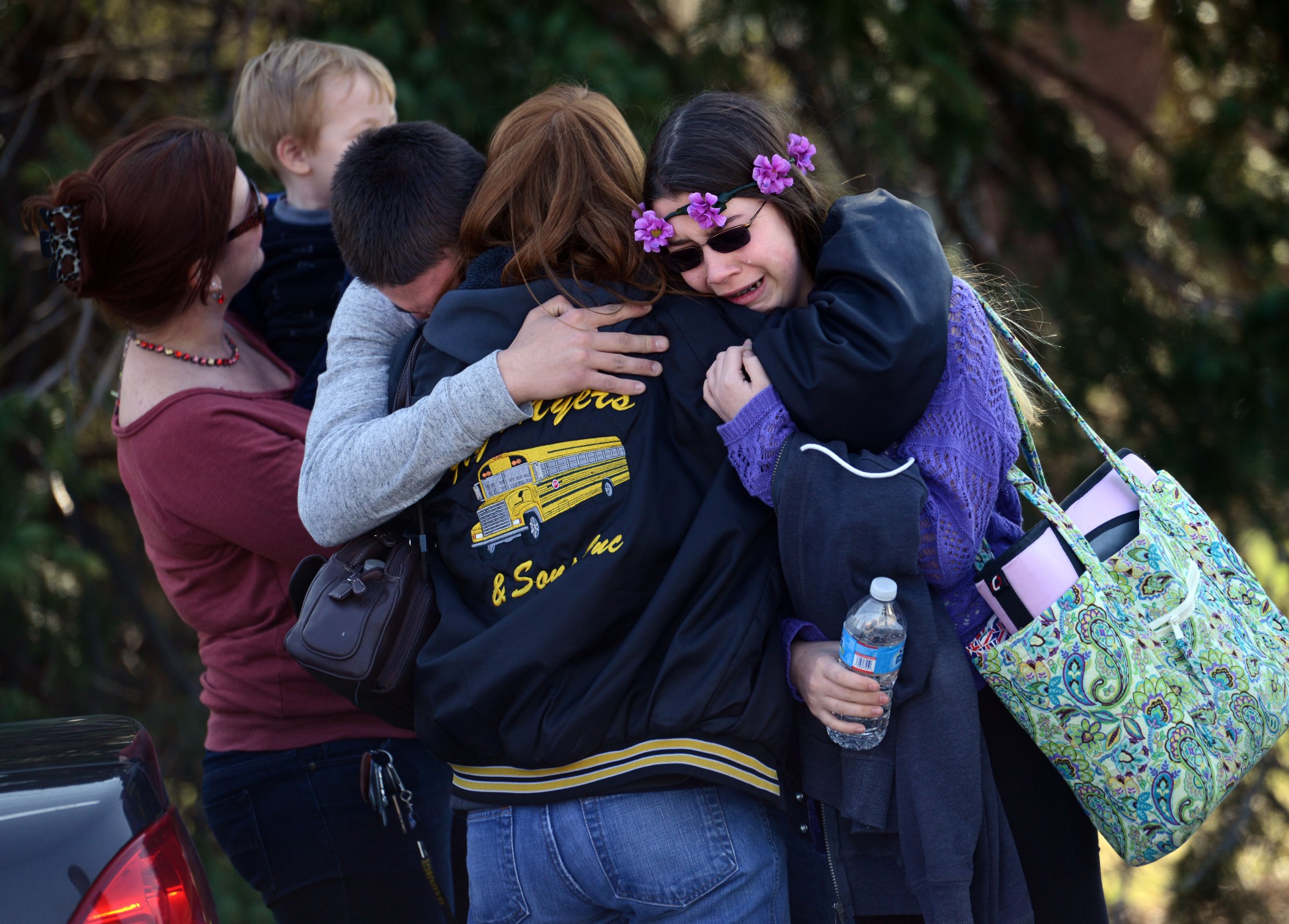 Parents and students embrace near Franklin Regional High School after more than a dozen students were stabbed by a knife wielding suspect at the school in Murrysville, Pa., April 9, 2014.