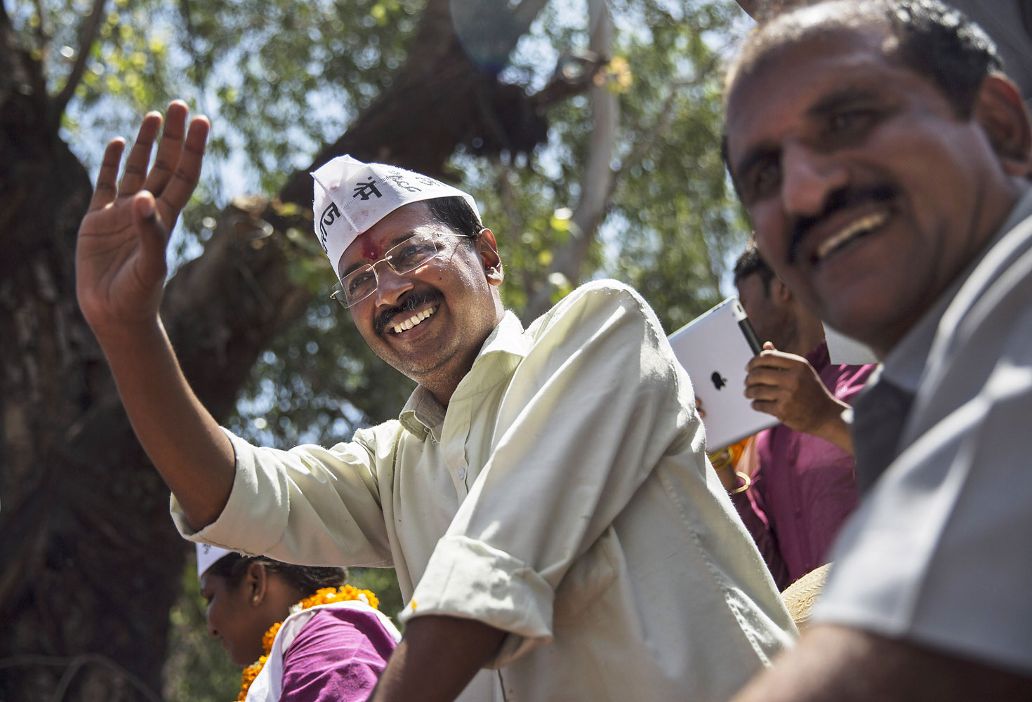 Leader of the AAP and anti-corruption activist  Arvind Kejriwal waves to supporters while campaigning on April 8, 2014 in New Delhi. (Kevin Frayer—Getty Images)