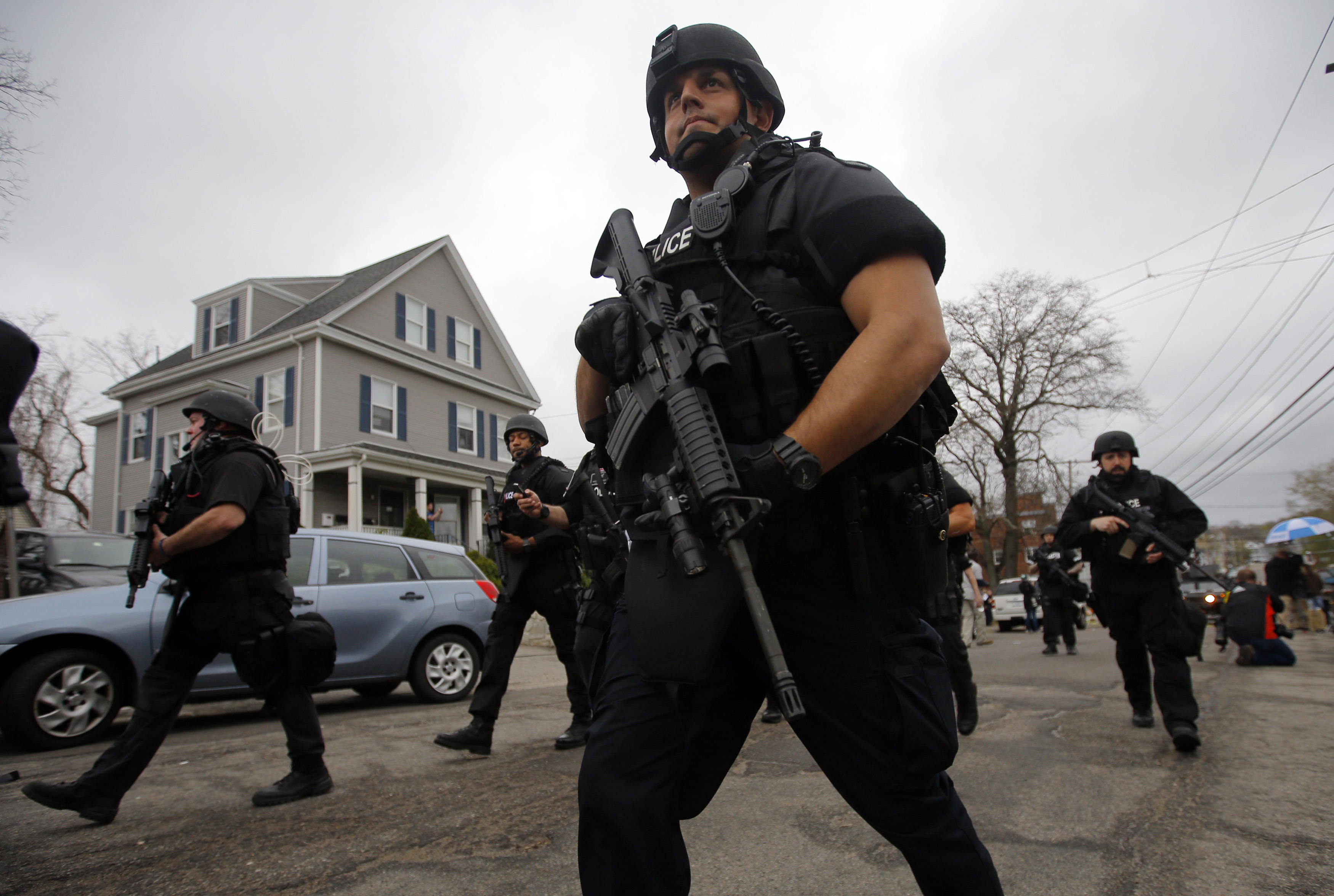 Police officers searched house to house for Dzhokhar Tsarnaev, the surviving suspect in the Boston Marathon bombings, in a neighborhood in Watertown, Mass., on April 19, 2013.