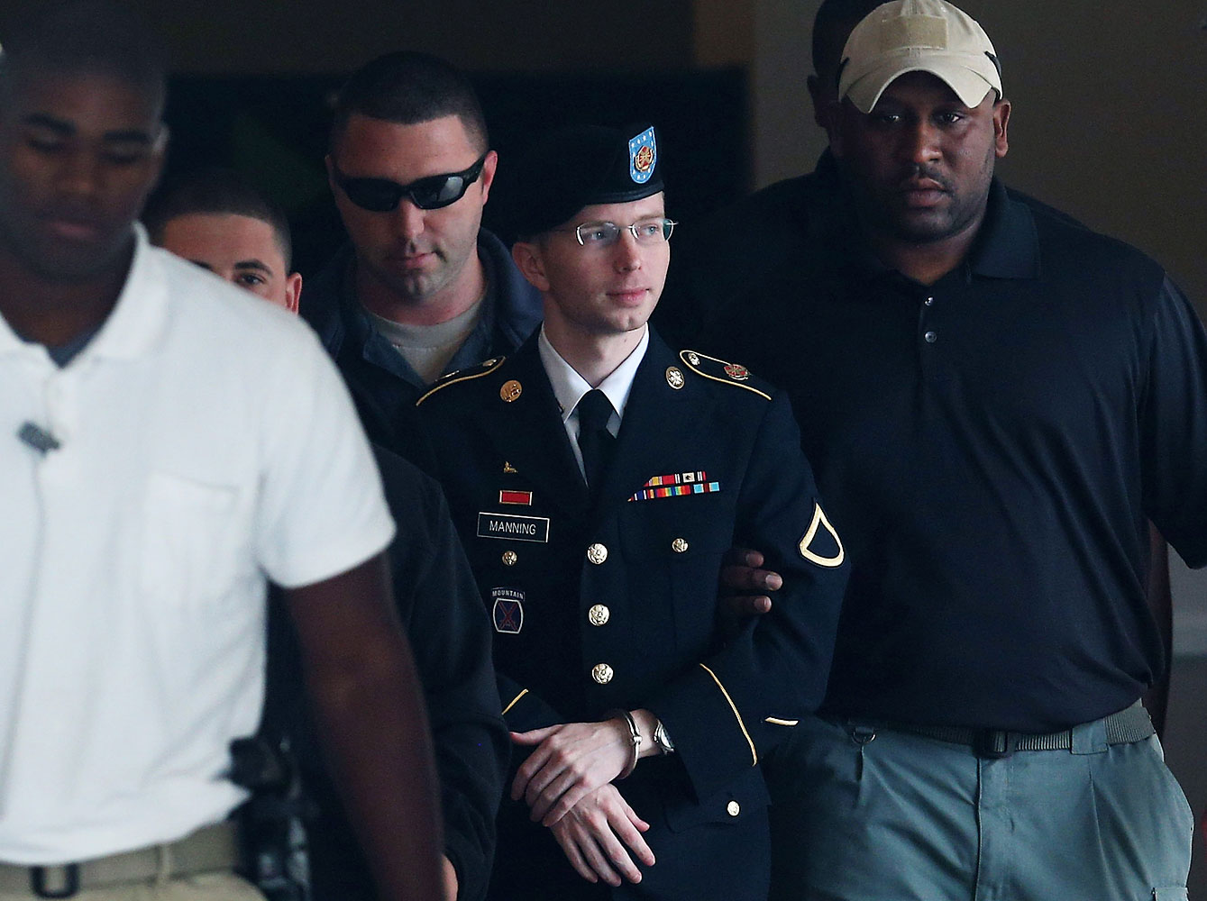 Bradley Manning, now known as Chelsea Manning, being escorted out of a military-court facility in Fort Meade, Md., on Aug. 20, 2013 (Mark Wilson—Getty Images)
