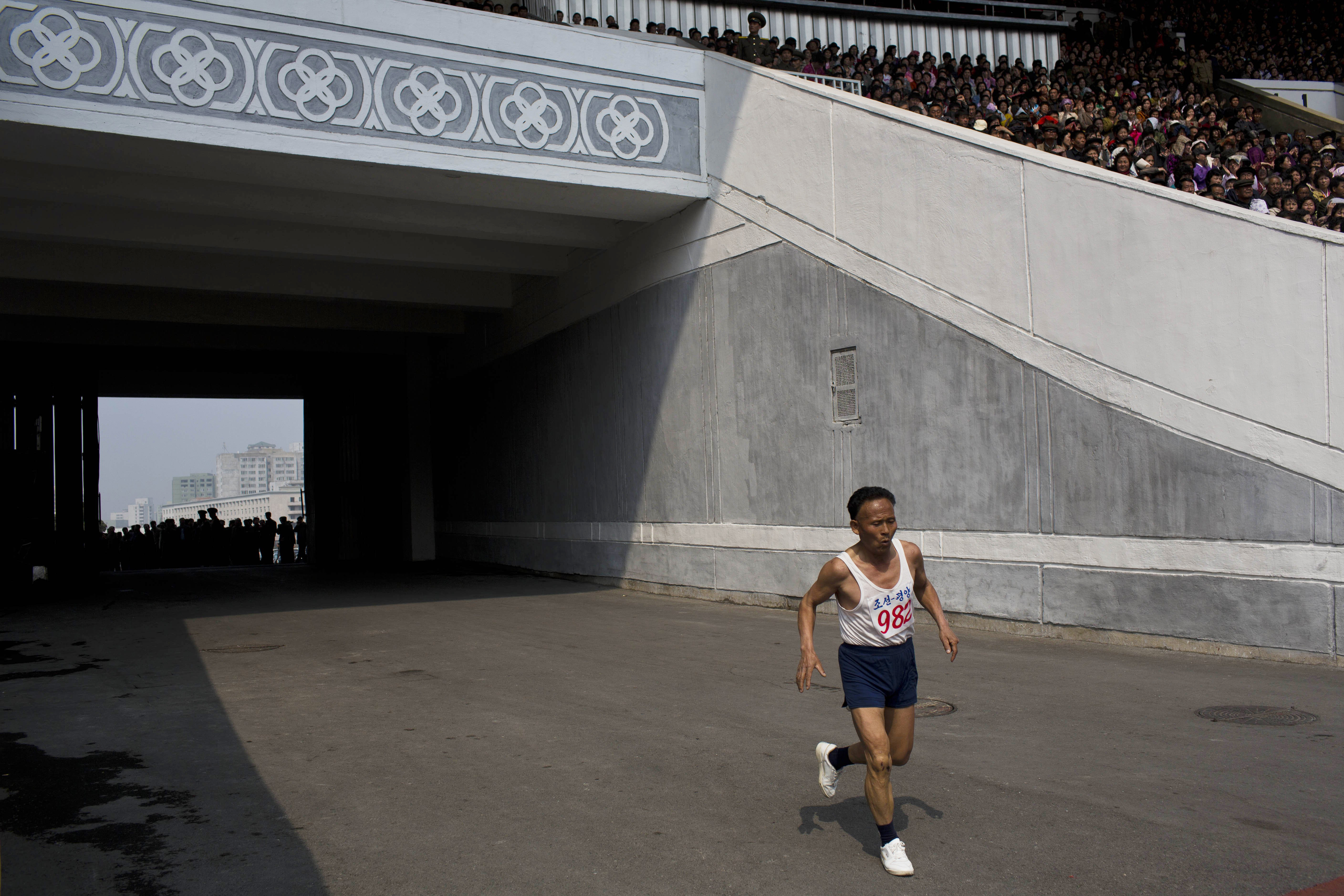 Apr. 13, 2014. An elderly North Korean man enters Kim Il Sung Stadium at the last stretch of his run during the Mangyongdae Prize International Marathon in Pyongyang, North Korea. The annual race, which includes a full marathon, a half marathon, and a 10-kilometer run, was open to foreign tourists for the first time this year.