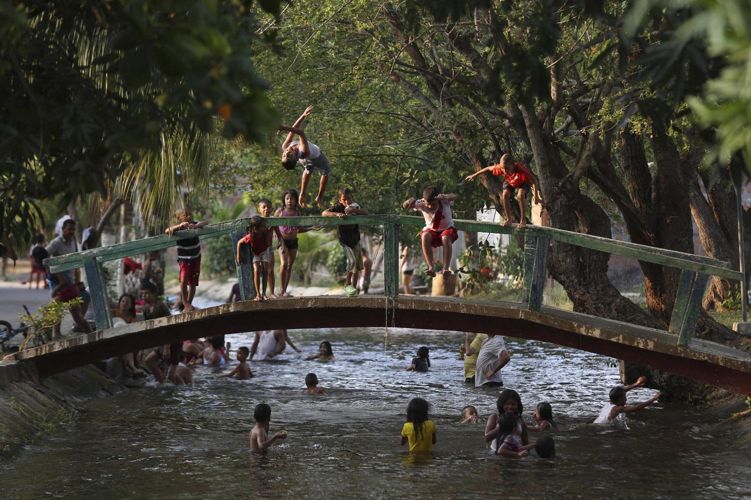 Apr. 18, 2014. Children play in an irrigation canal, the local swimming hole that runs though Aracataca, the hometown of the late Nobel laureate Gabriel Garcia Marquez along Colombia's Caribbean coast during the Holy Week holiday.