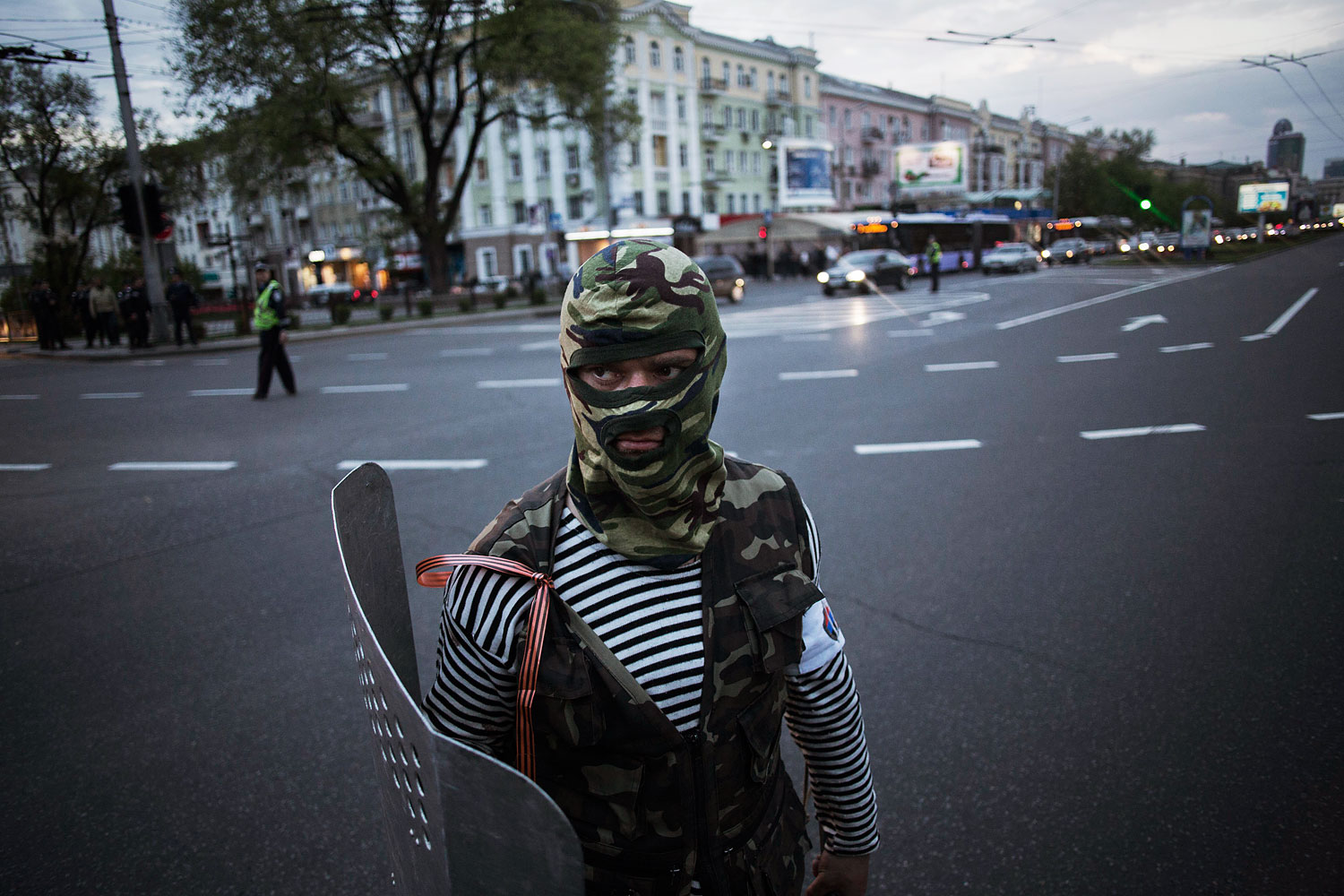 A pro-Russian activist is seen while holding a shield after clashing with pro Ukrainians during a pro Ukraine rally in Donetsk, Ukraine, Monday, April 28, 2014.