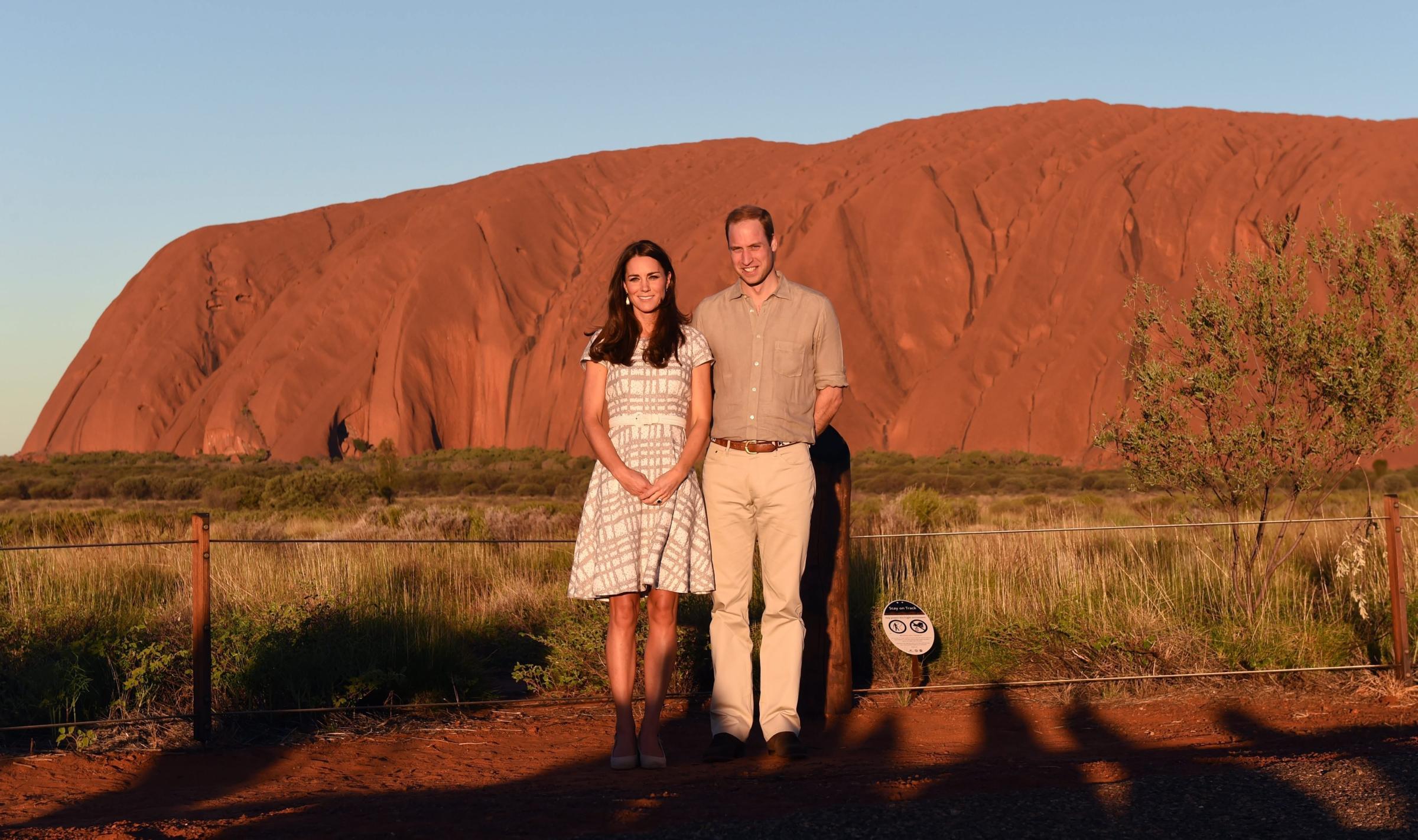 From right: Prince William, Duke of Cambridge and his wife Catherine, Duchess of Cambridge stand in front of Uluru in the Northern Territory, Australia, April 22, 2014.