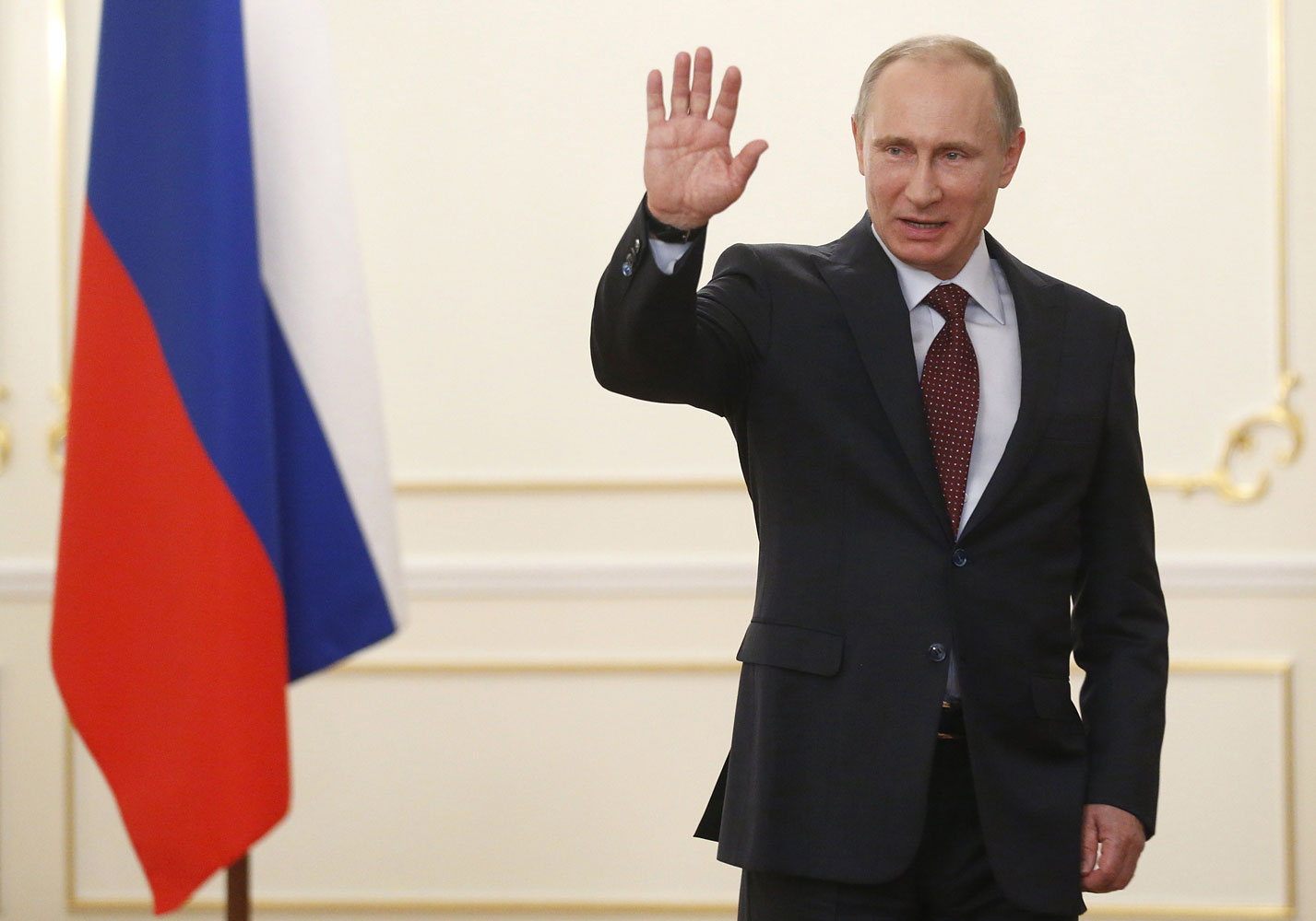 Vladimir Putin waves in his Novo-Ogaryovo residence outside Moscow, on April 18, 2014. (Maxim Shipenkov—AFP/Getty Images)