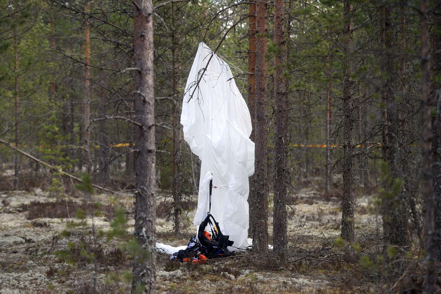 Apr. 21, 2014. A parachute hangs from a tree close to the wreckage of a small airplane in a forest next to an airfield in southwest Finland. The Comp Air 8 plane taking a group of skydivers for an Easter Day jump crashed on Easter Sunday, April 20, 2014, killing eight people, police said.