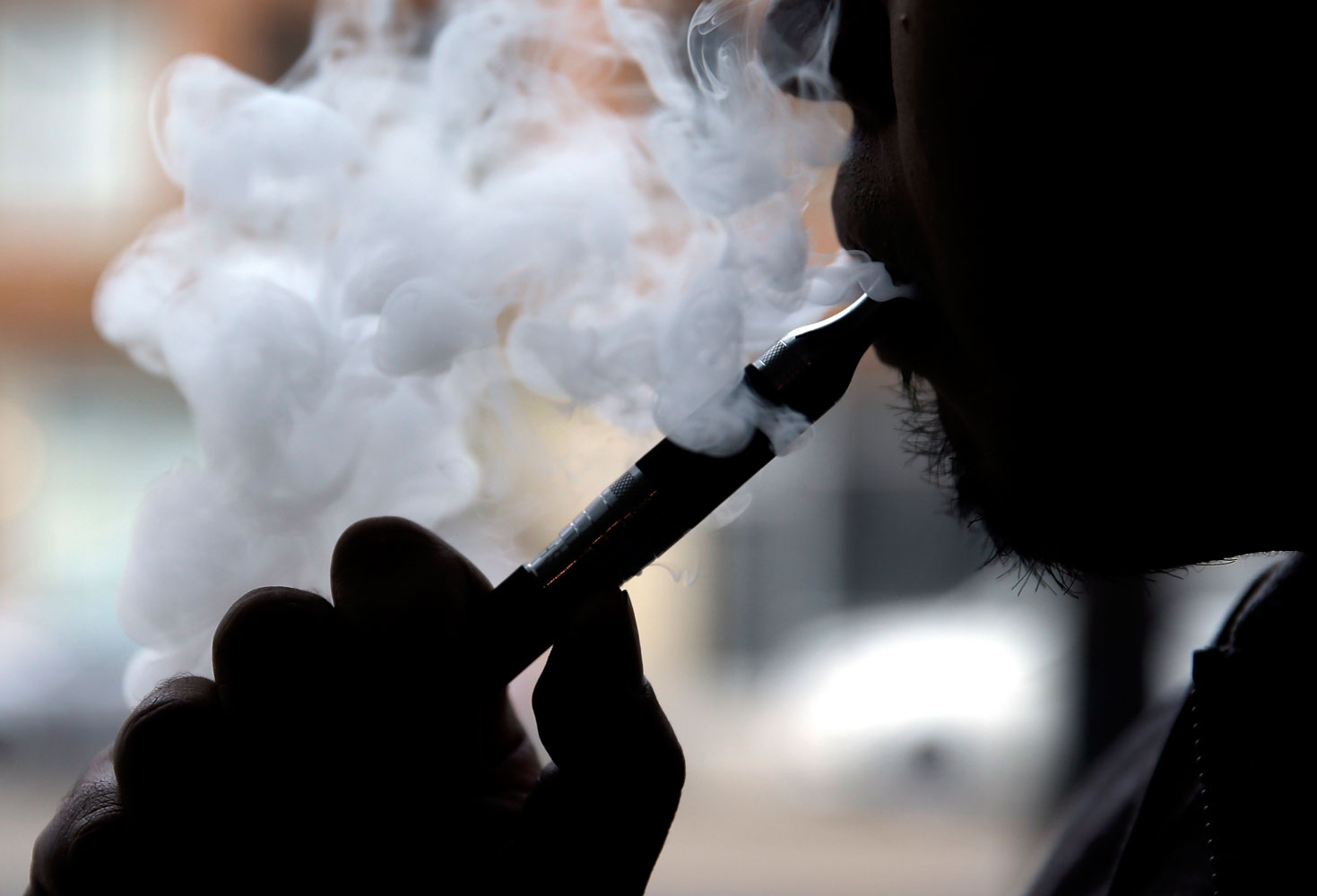A patron demonstrates an e-cigarette at Vape store in Chicago, April 23, 2014.