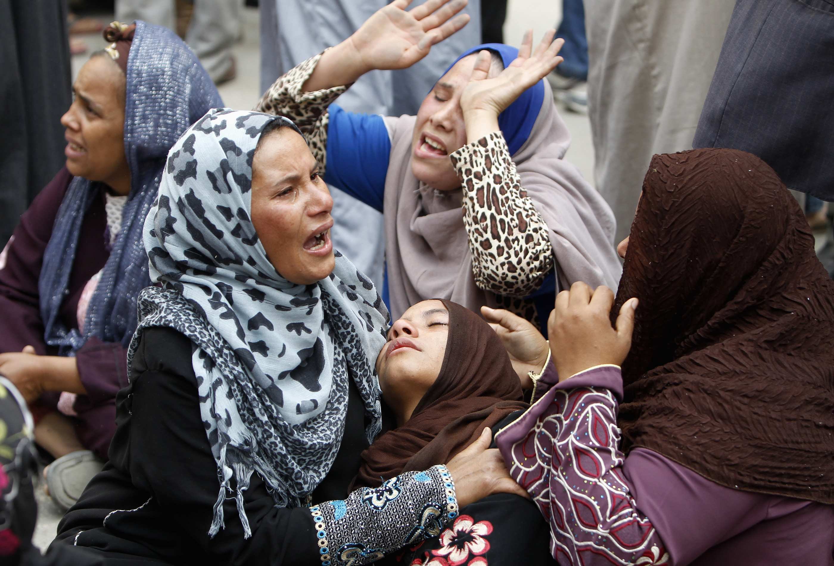 Relatives and families of members of the Muslim Brotherhood and supporters of ousted President Mohamed Morsi react after hearing the sentence, in front of the court in Minya, south of Cairo, Apr. 28, 2014. (Mohamed Abd El Ghany—Reuters)