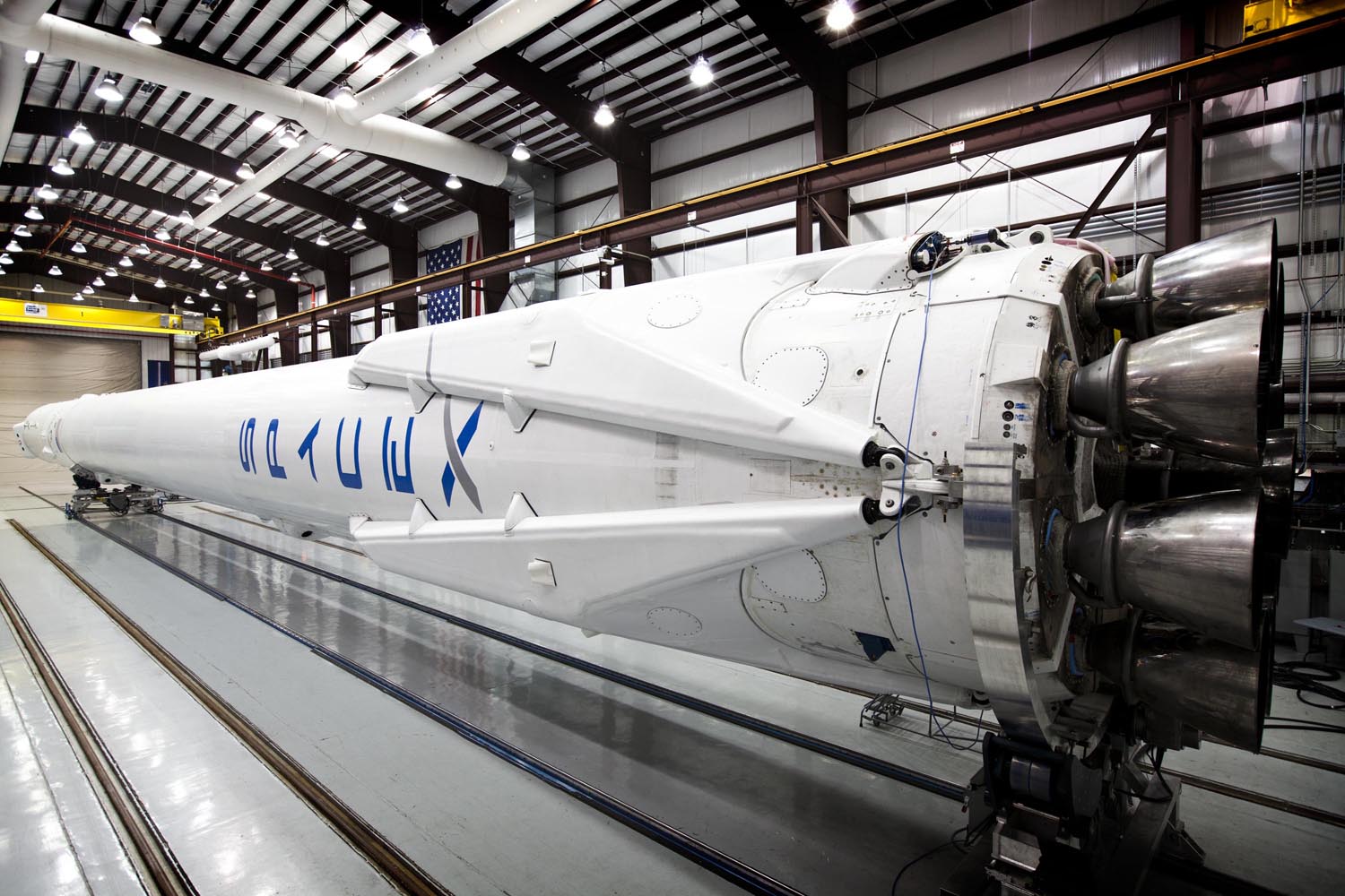 Falcon 9 awaits its upcoming launch in SpaceX's hangar with landing legs attached on March 12, 2014.