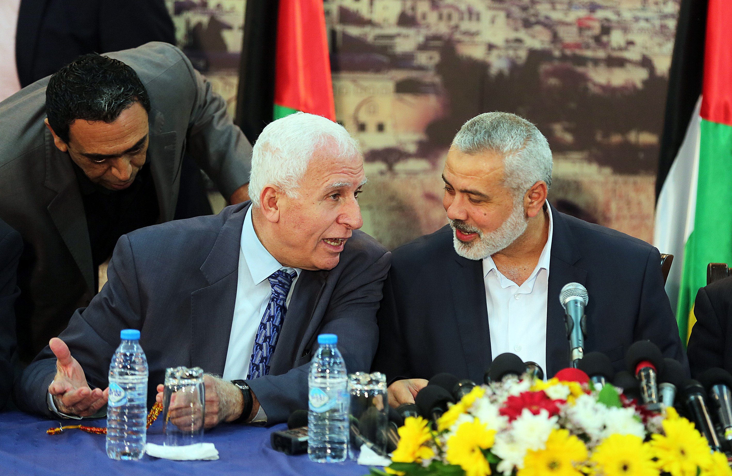 From left: Fatah movement Leader Azzam Al-Ahmad and Palestinian Prime Minister Ismail Haniyeh speak during a press conference following the meeting to end Palestinian divisions between Fatah and Hamas movement in Gaza City on April 23, 2014.