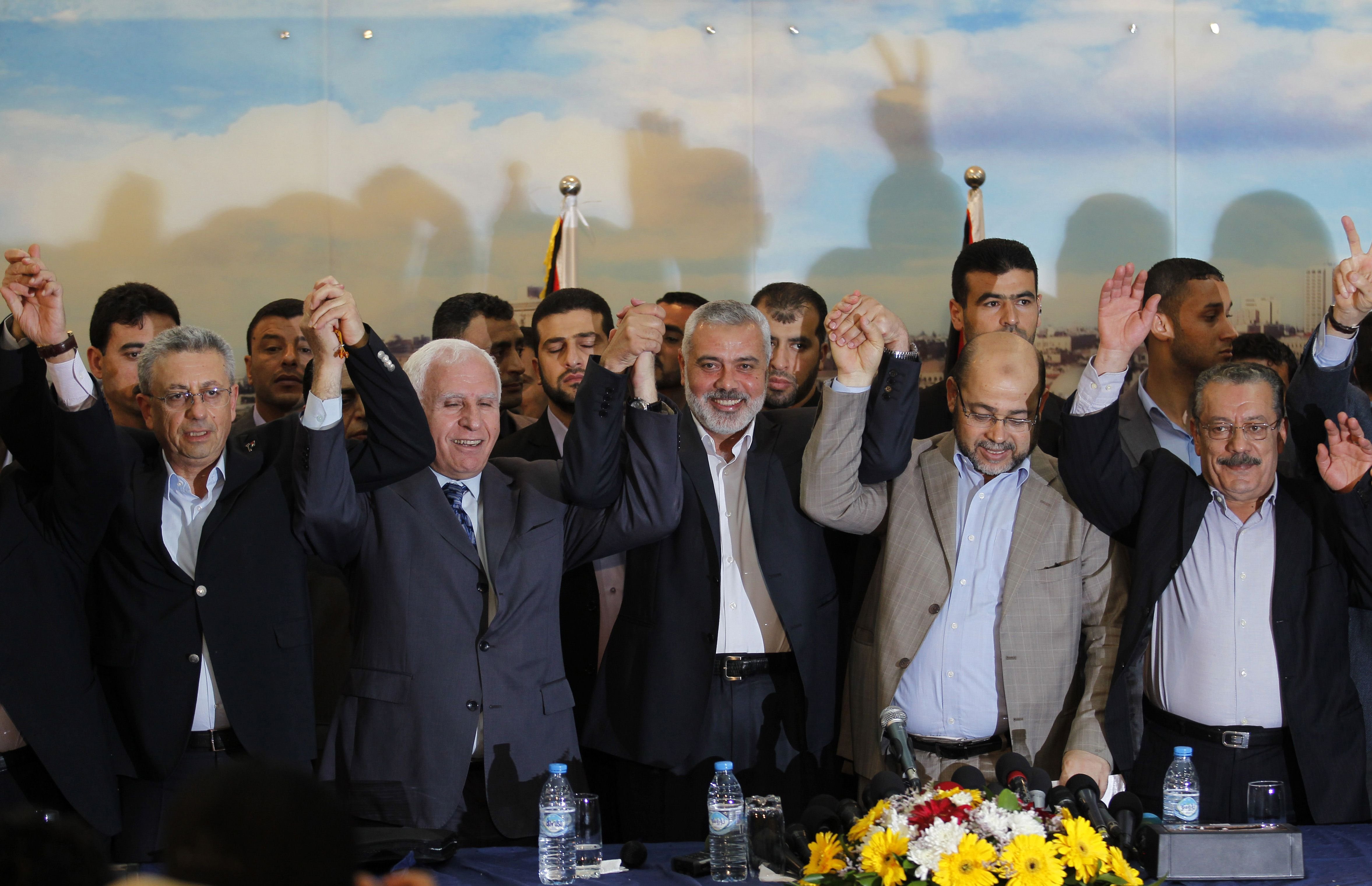 From left: Palestinian legislator Mustafa Barghouti, Palestinian Fatah delegation chief Azzam al-Ahmed, Hamas prime minister in the Gaza Strip Ismail Haniya, Hamas deputy leader Musa Abu Marzuk, and secretary-general of the Palestinian Arab Front (PAF) Jameel Shehadeh in Gaza on April 23, 2014.
